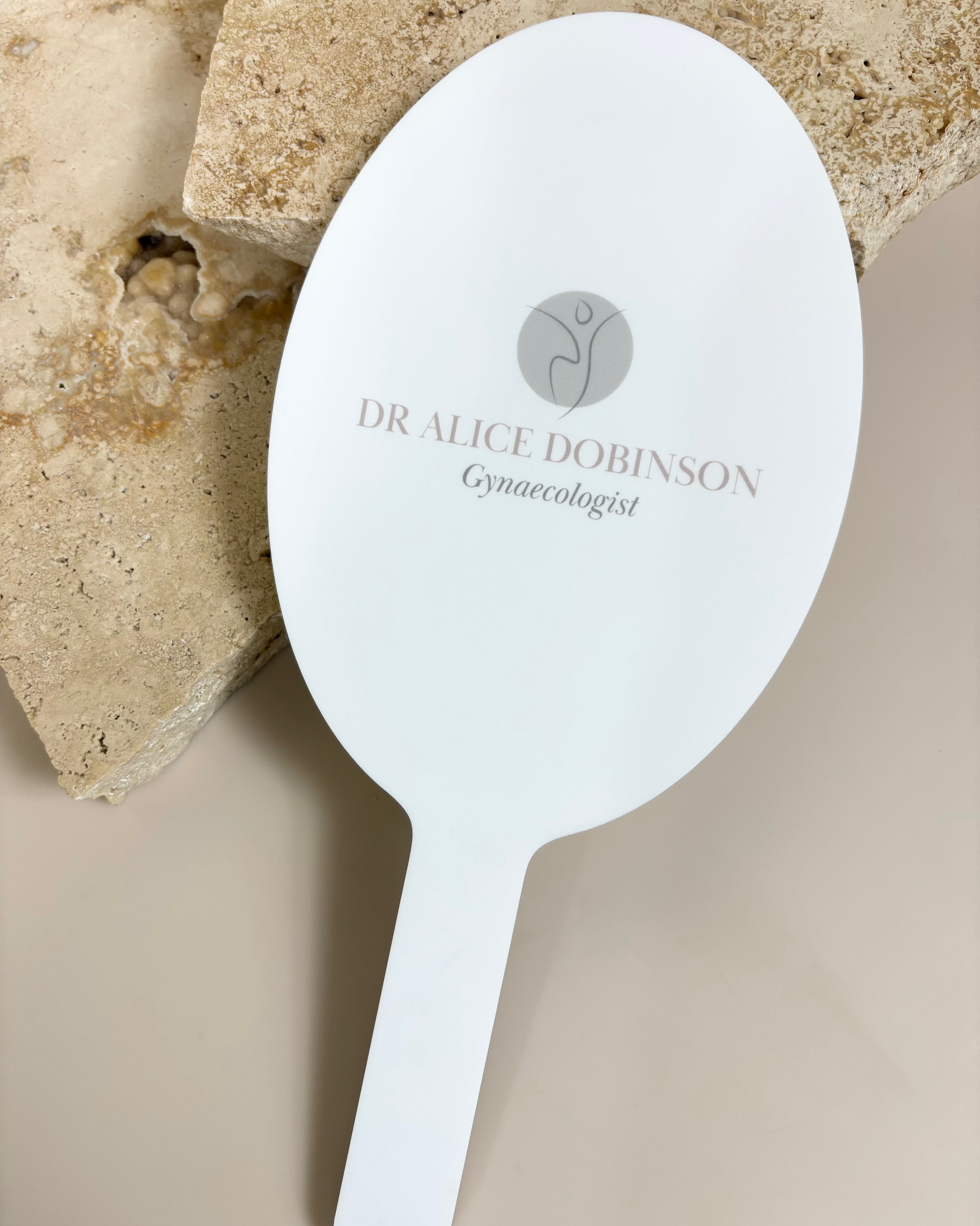 Personalised oval mirror with Dr Silk and Benson logo for clinics