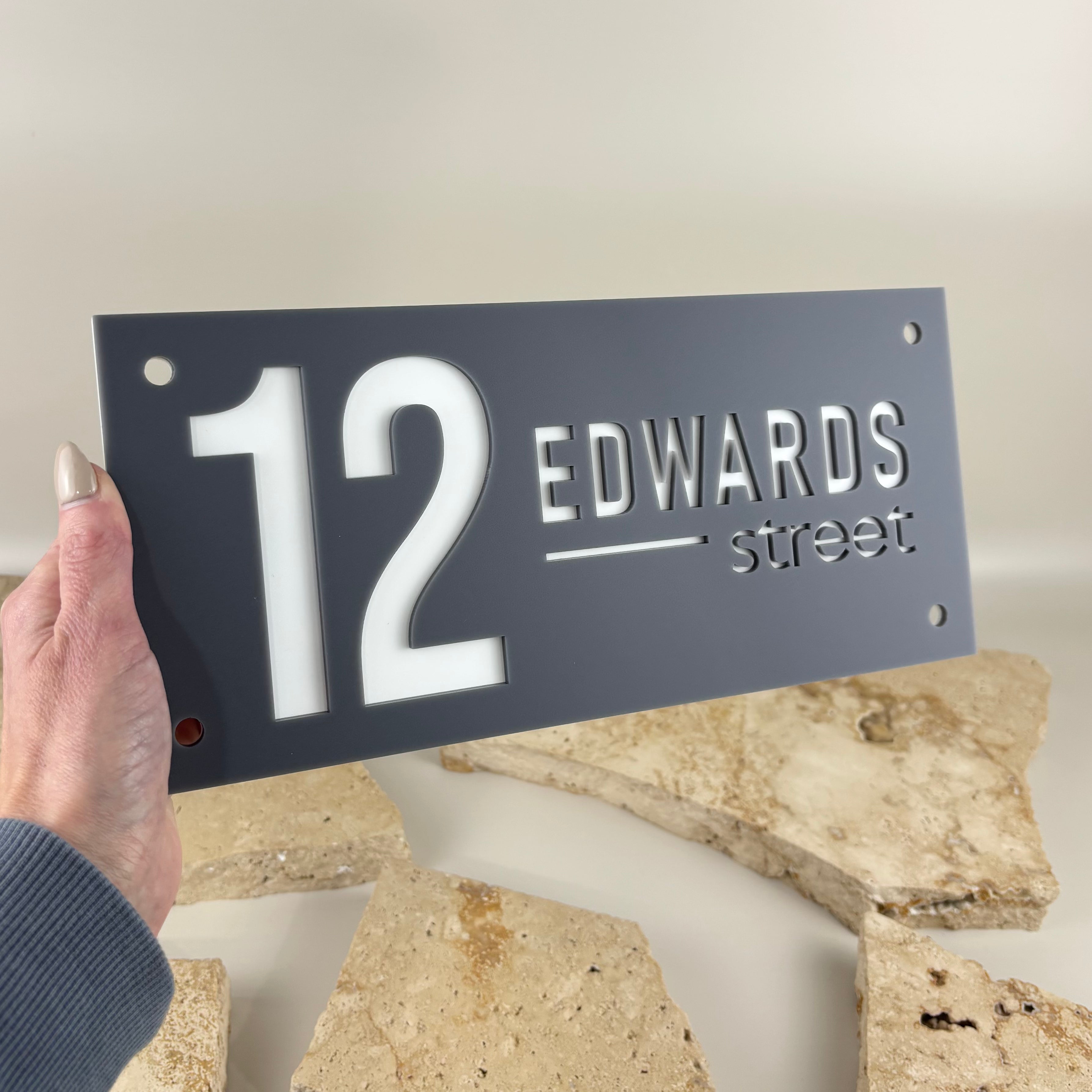 Custom grey and white acrylic house address sign with raised 3D number 12 and Edwards Street lettering.