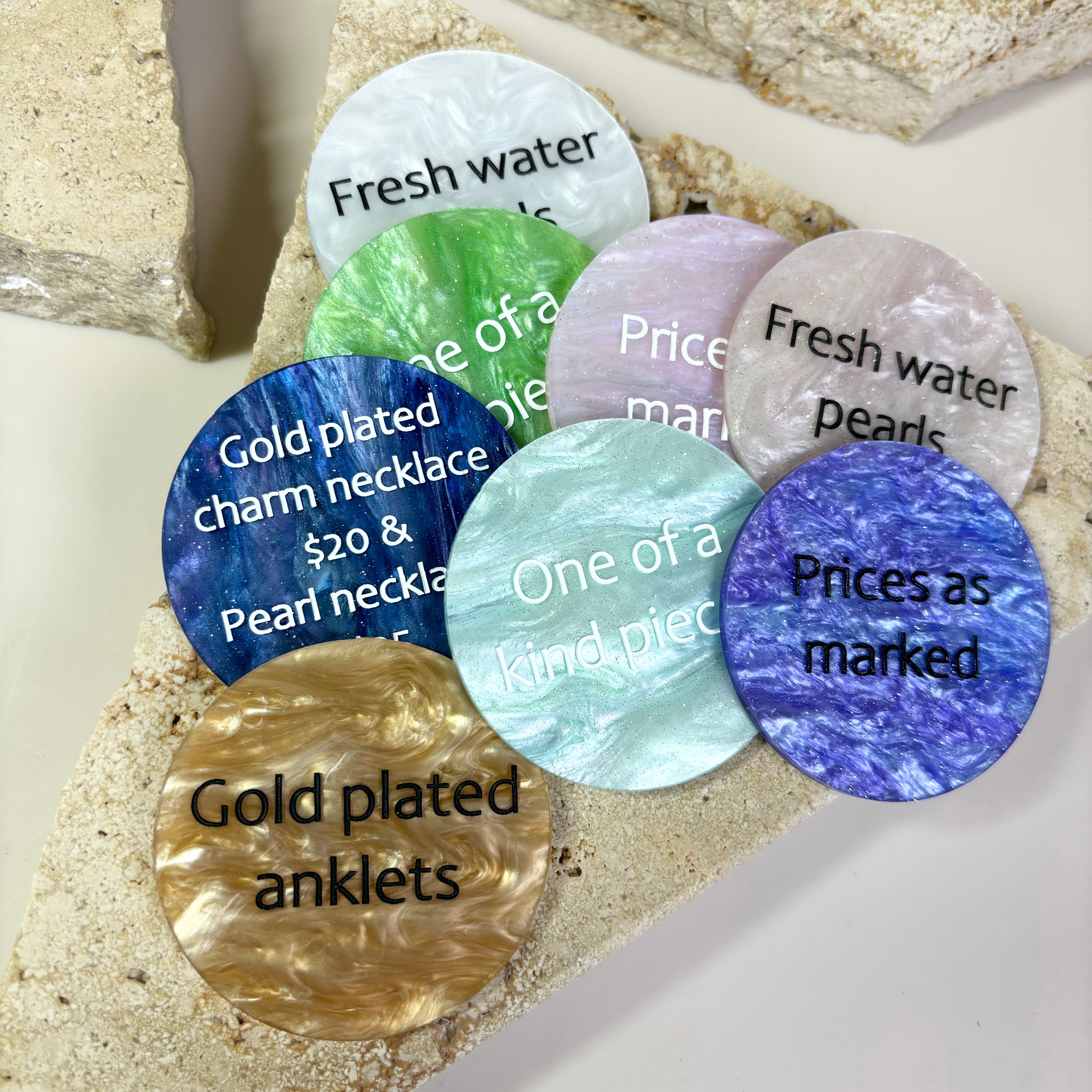 Set of colourful product price discs with engraved category names and prices