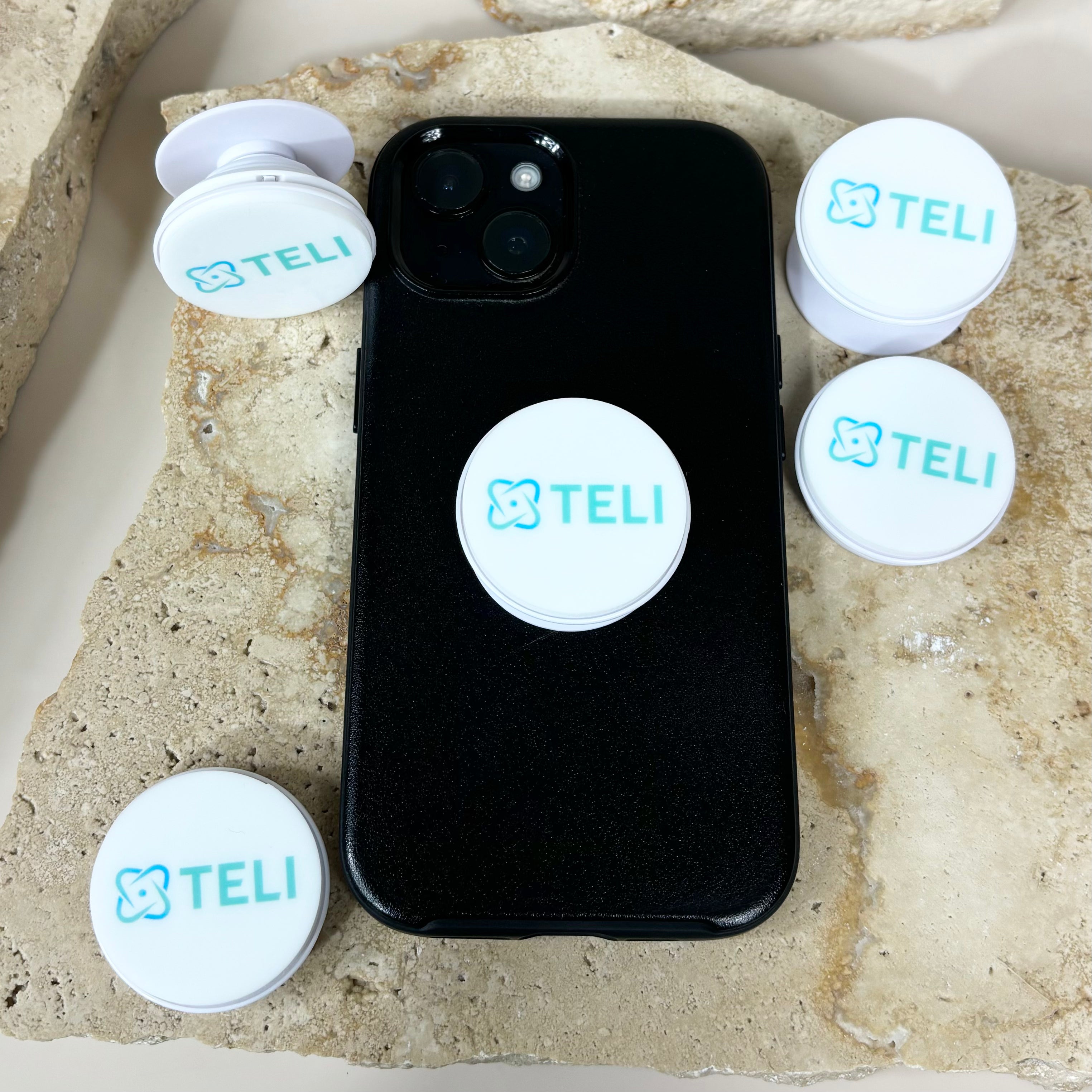 Set of custom logo phone grips on black smartphone case