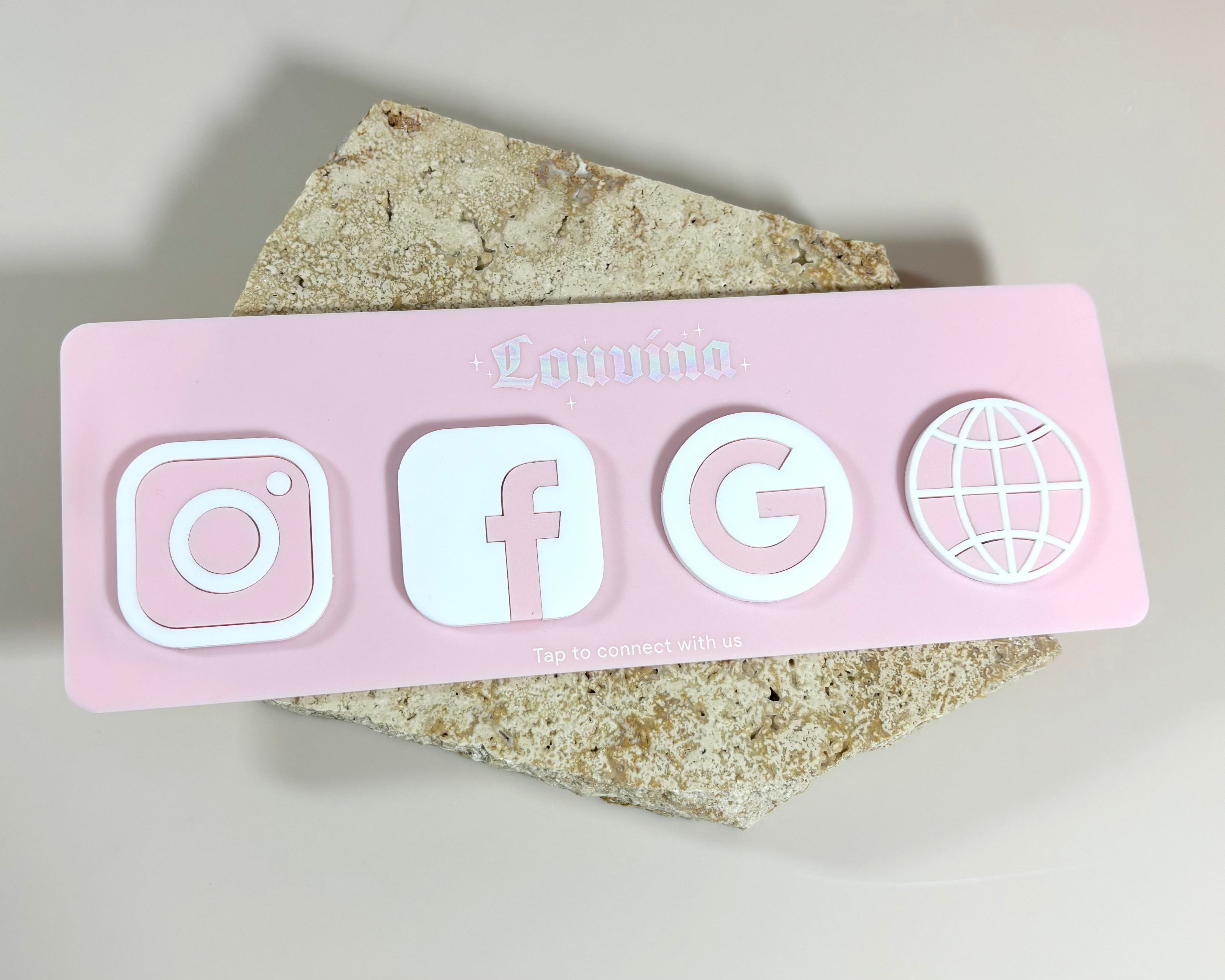 Pink NFC social plaque with Instagram, Facebook, Google and website icons for easy tap sharing.