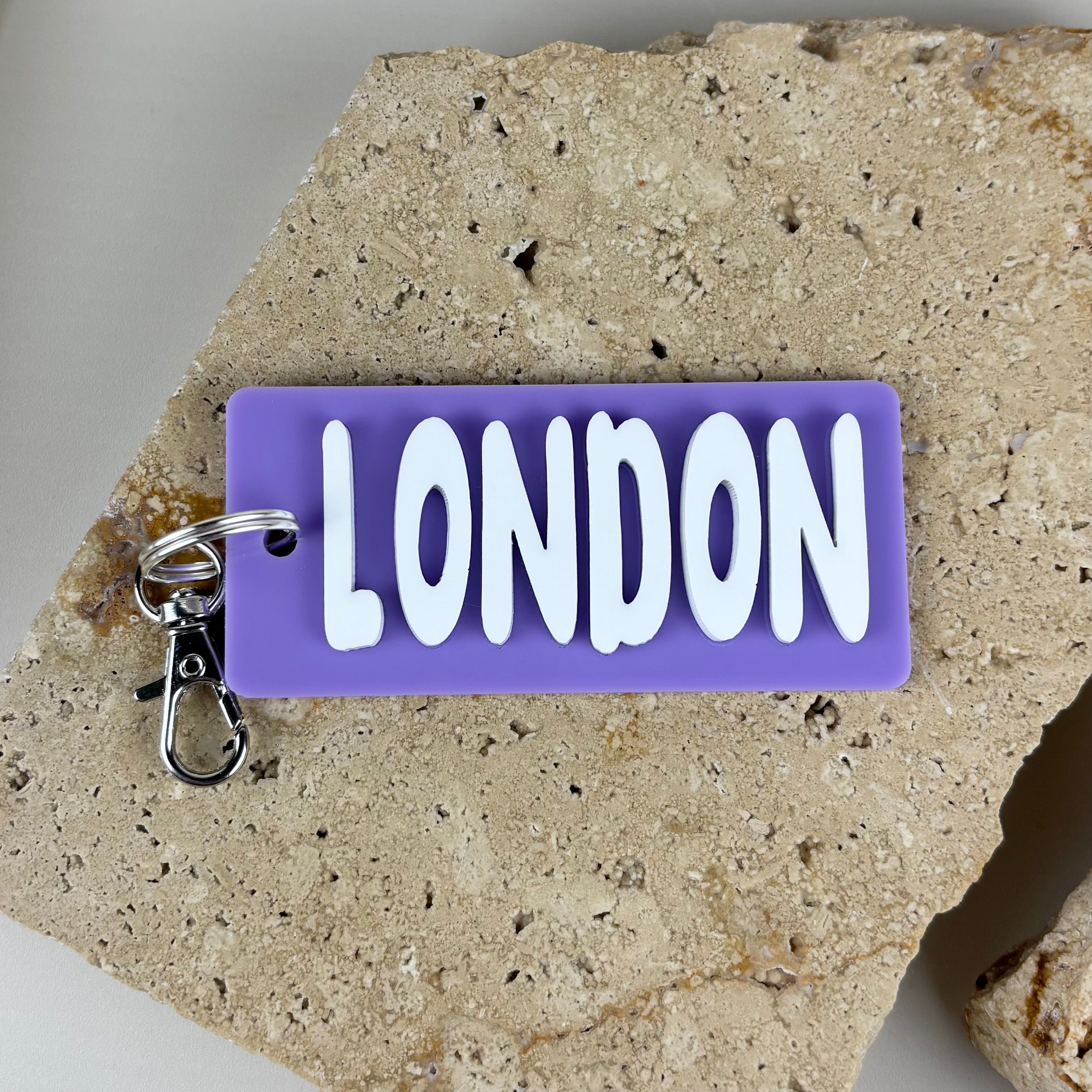 Personalised acrylic name keyring in purple and white with 3D lettering, custom name keychain made in Australia