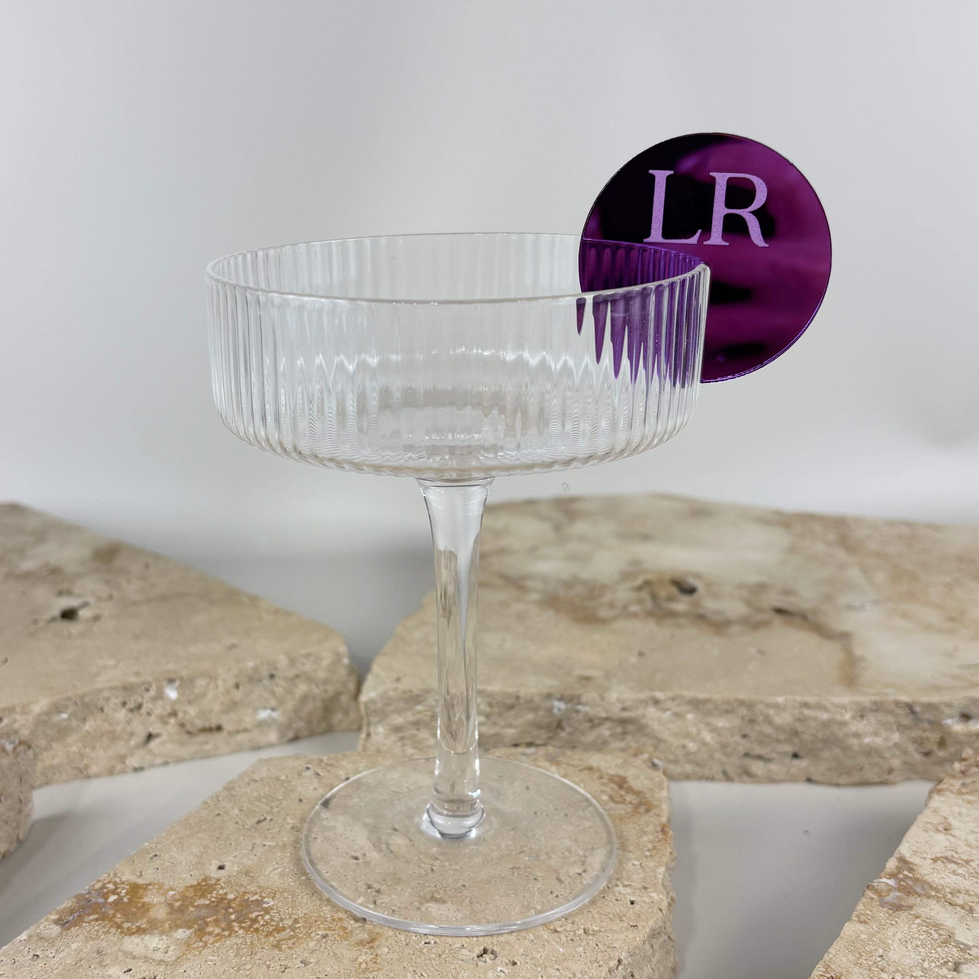 Coupe cocktail glass with personalised purple acrylic drink stirrer, custom monogram drink accessory for weddings and parties