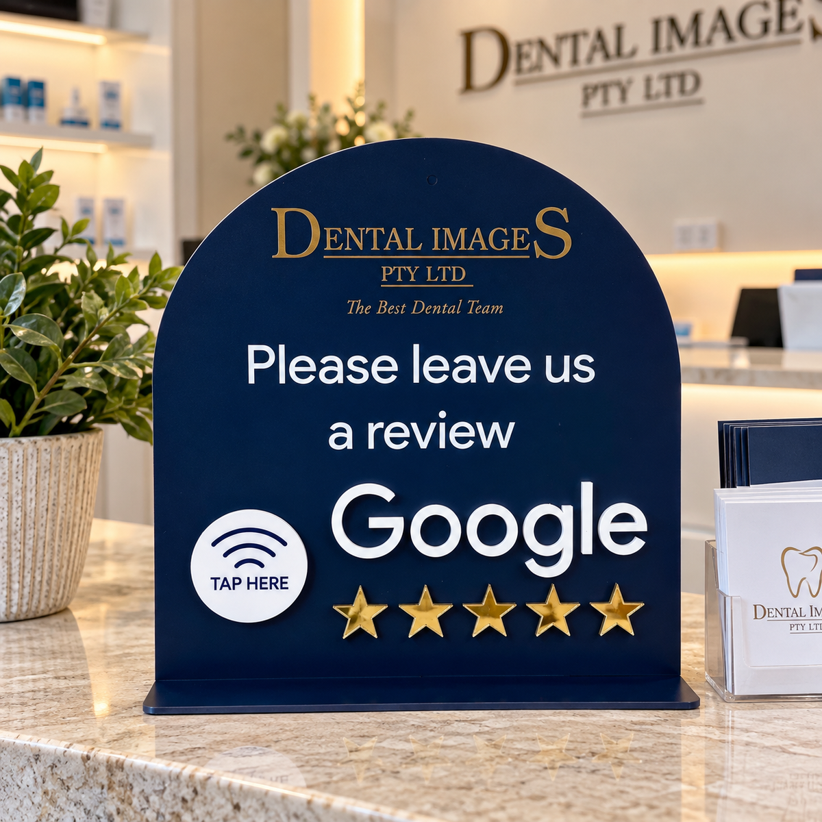 Custom NFC Google review stand for a dental clinic, featuring raised 3D acrylic lettering, tap-to-review icon and five gold stars on a reception counter.