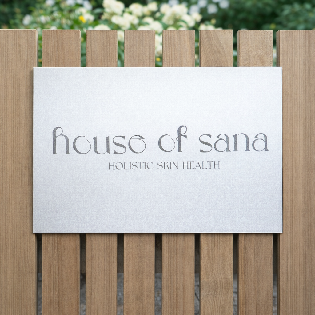 Custom aluminium business sign mounted on an aesthetic timber fence for a skin clinic, featuring “House of Sana – Holistic Skin Health”, modern outdoor signage for beauty and aesthetic salons