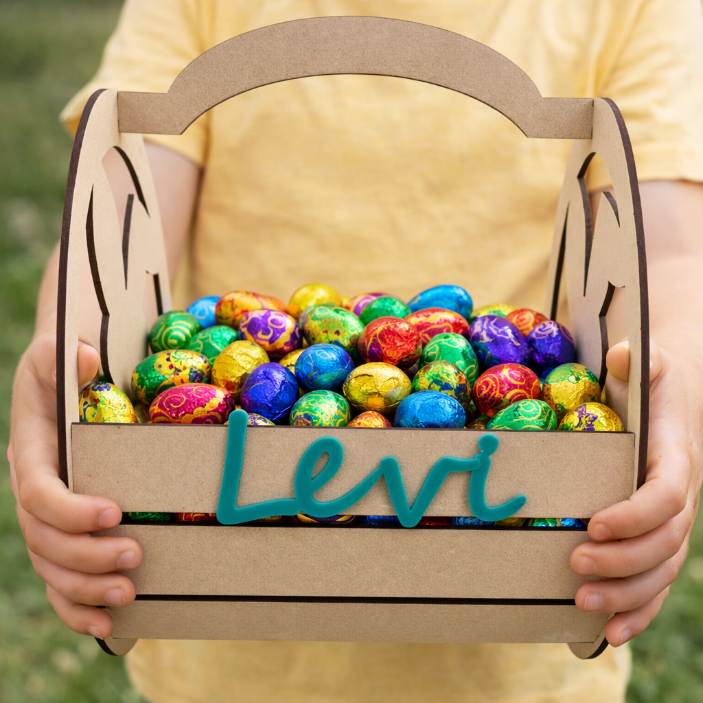Personalised wooden Easter basket filled with colourful foil Easter eggs, custom name Easter basket for kids held by child