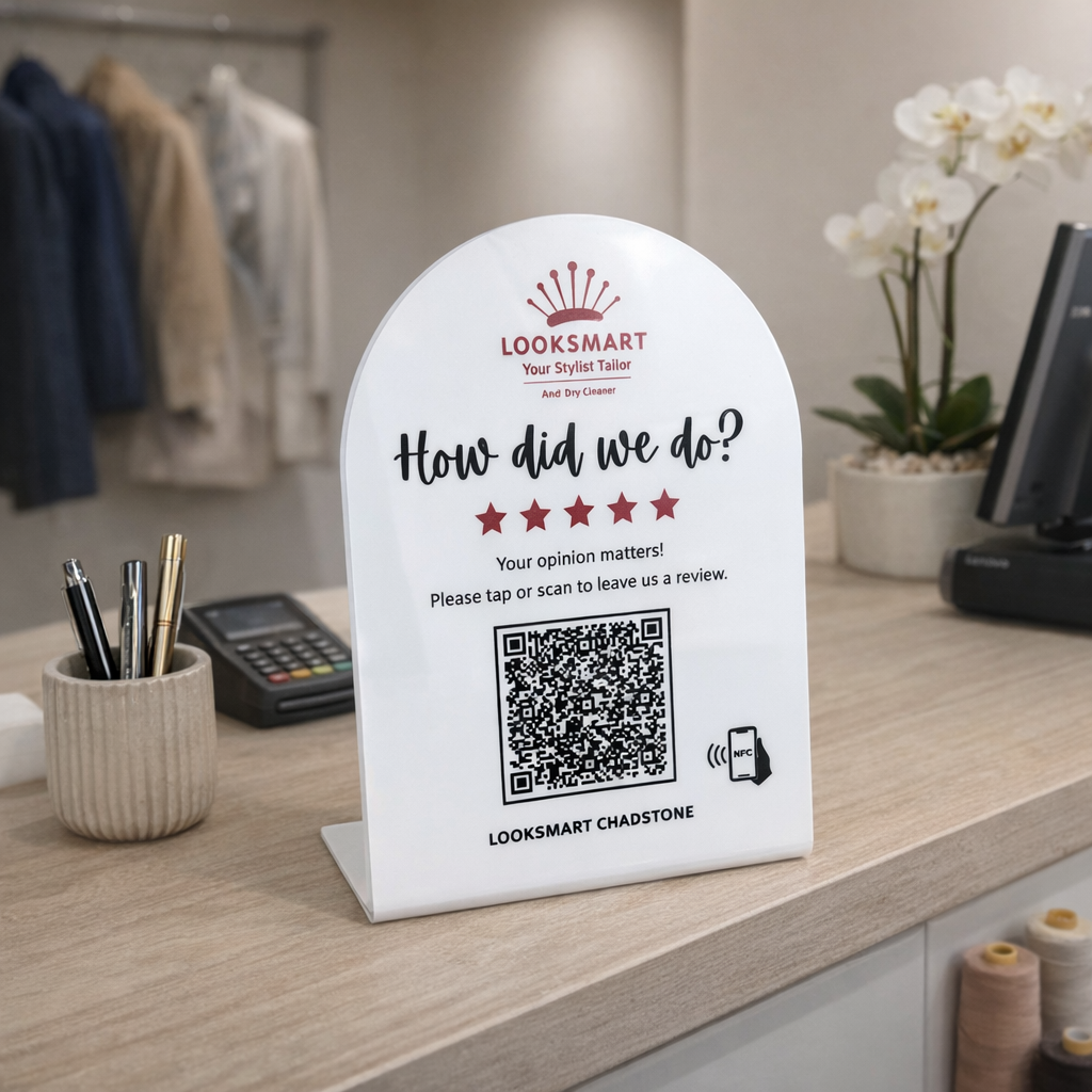 Custom acrylic Google review stand with QR code and NFC tap feature displayed on tailoring shop counter desk encouraging customers to leave a review, branded business counter signage for retail stores and service businesses in Australia.