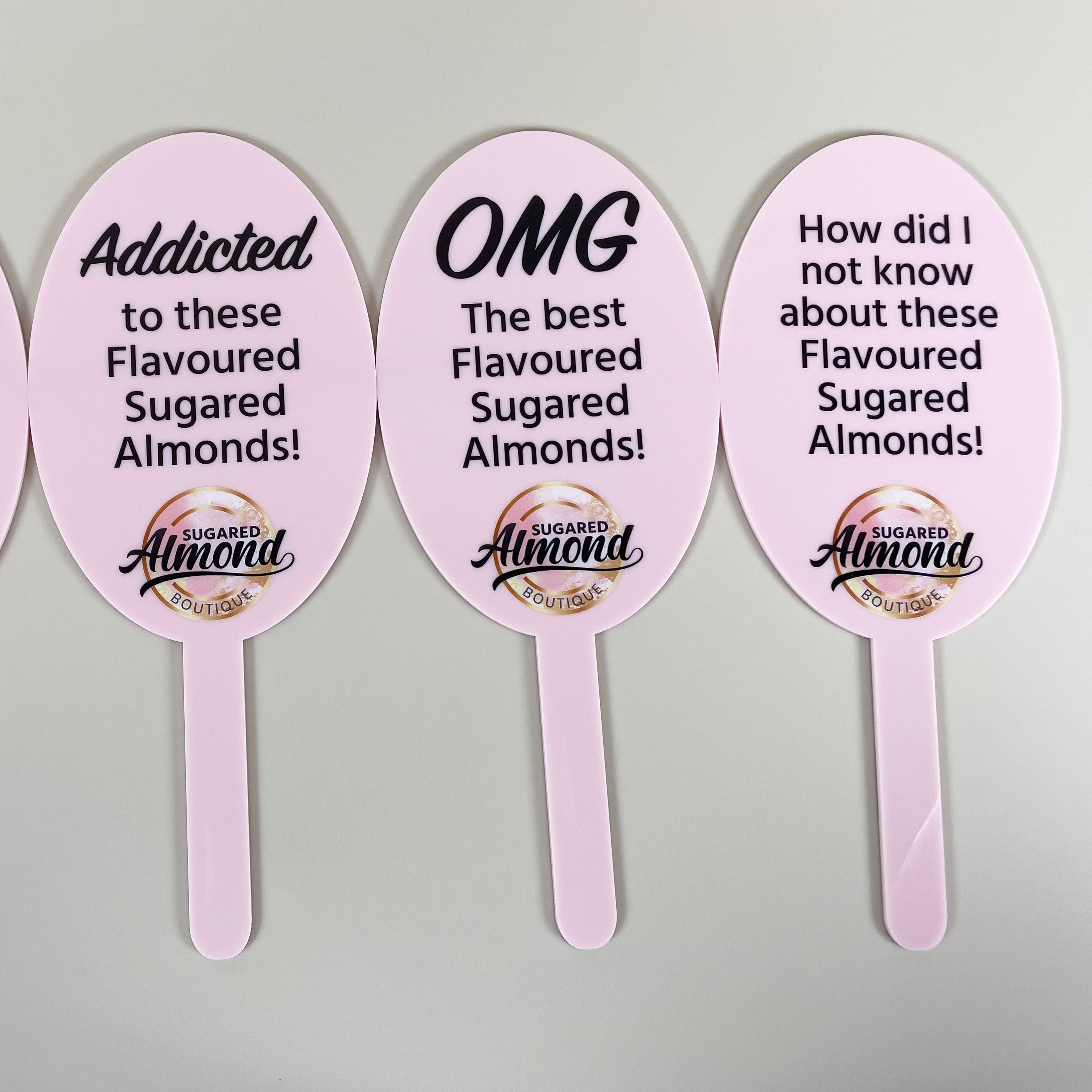 Multiple branded prop paddles displayed with playful marketing messages