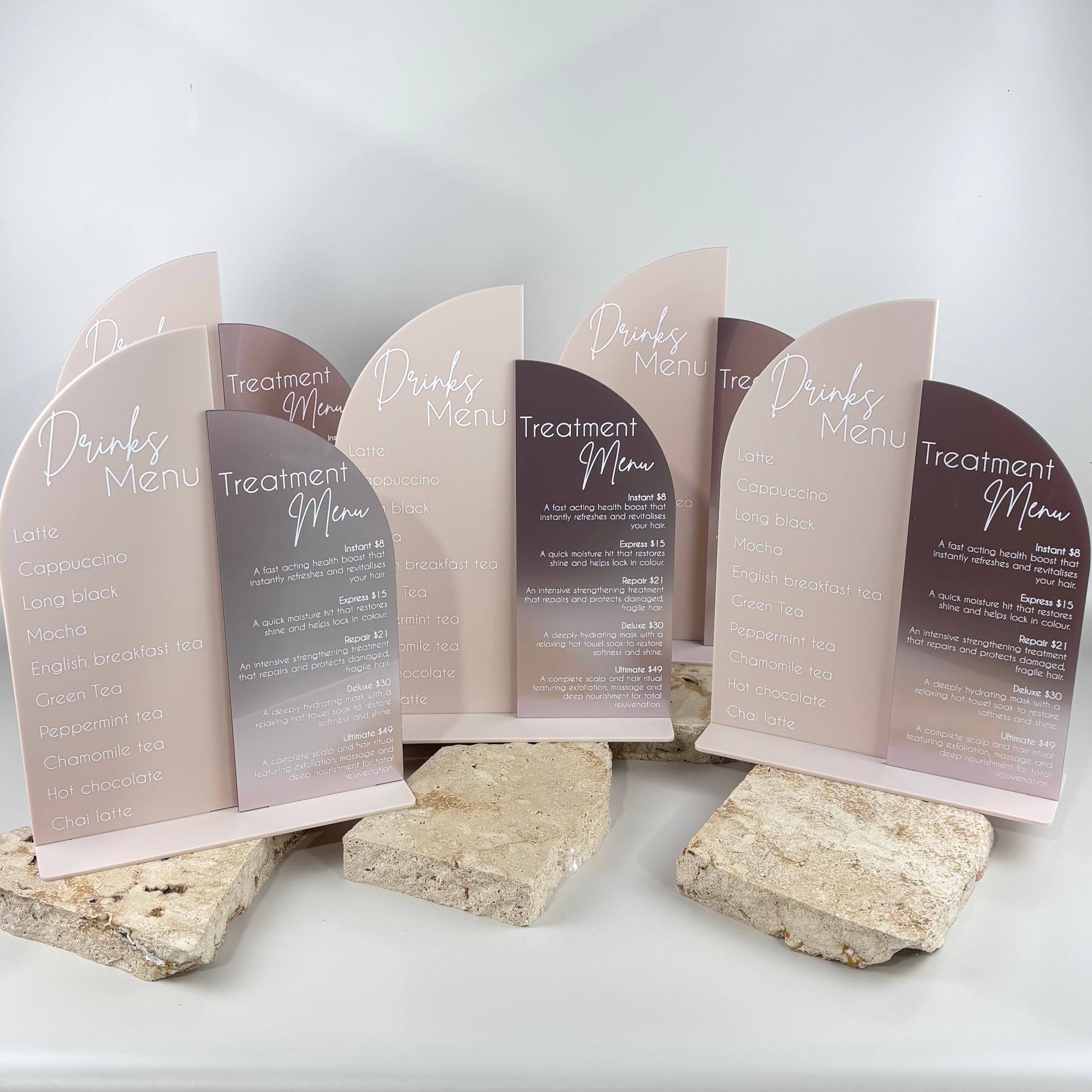 Set of curved acrylic menu stands in neutral tones displaying “Drinks Menu” and “Treatment Menu”, modern salon counter signage, UV printed business display stands, aesthetic retail POS signage Australia