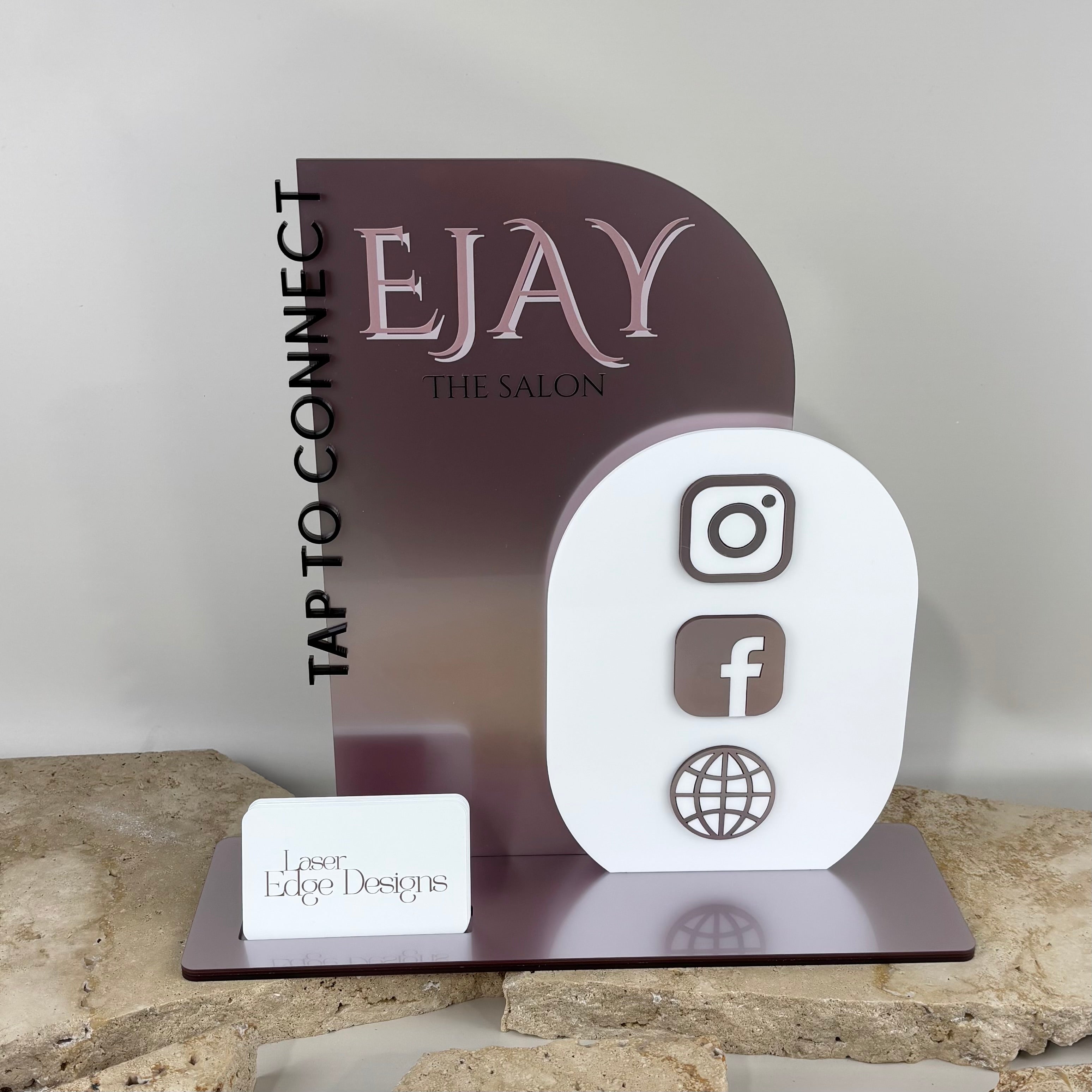 Custom NFC business station for salons, acrylic social media display stand with logo EJAY The Salon, Instagram Facebook website icons sign, tap to connect contactless display, modern reception counter signage Australia, branded business card holder stand, aesthetic acrylic desk display for beauty salons and small business branding
