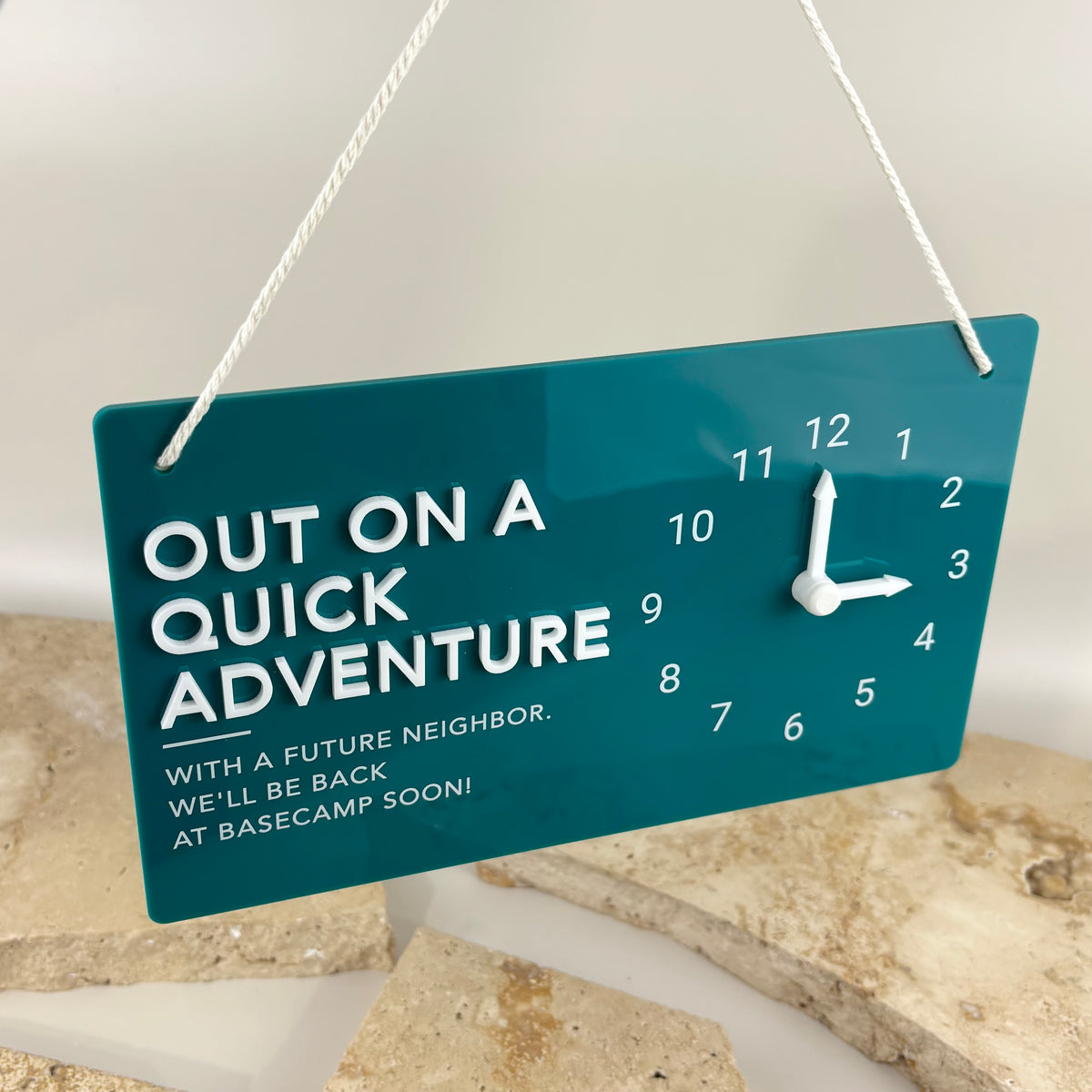 Custom teal acrylic hanging business sign with 3D lettering and movable clock hands to show return time.