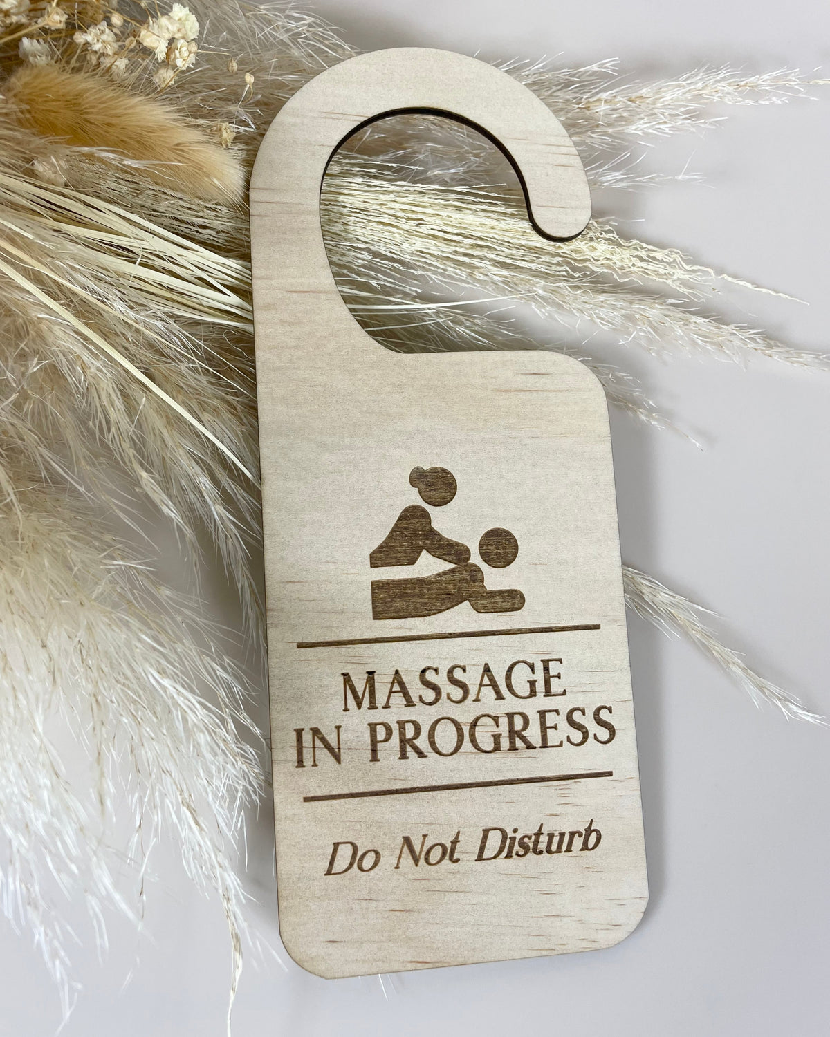 Custom laser engraved timber door hanger for Fitfever Fitness Montfoort, featuring a business logo and Massage in Progress, Do Not Disturb message.