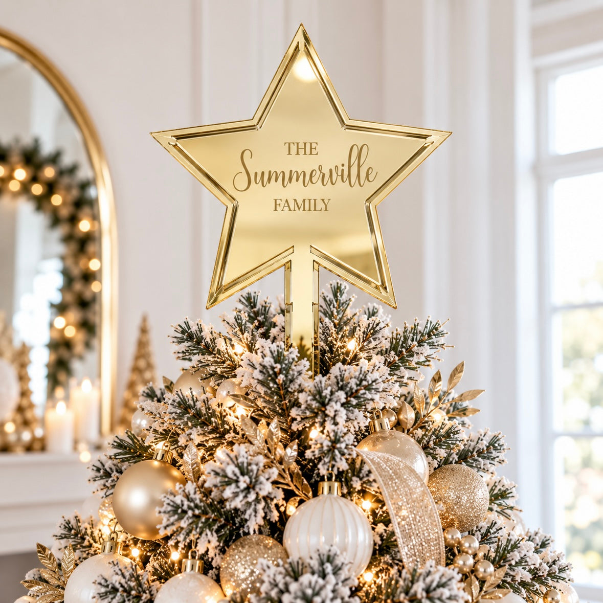 Personalised gold mirror acrylic Christmas tree star topper engraved with The Summerville Family, displayed on a light modern Christmas tree with gold and white decorations.
