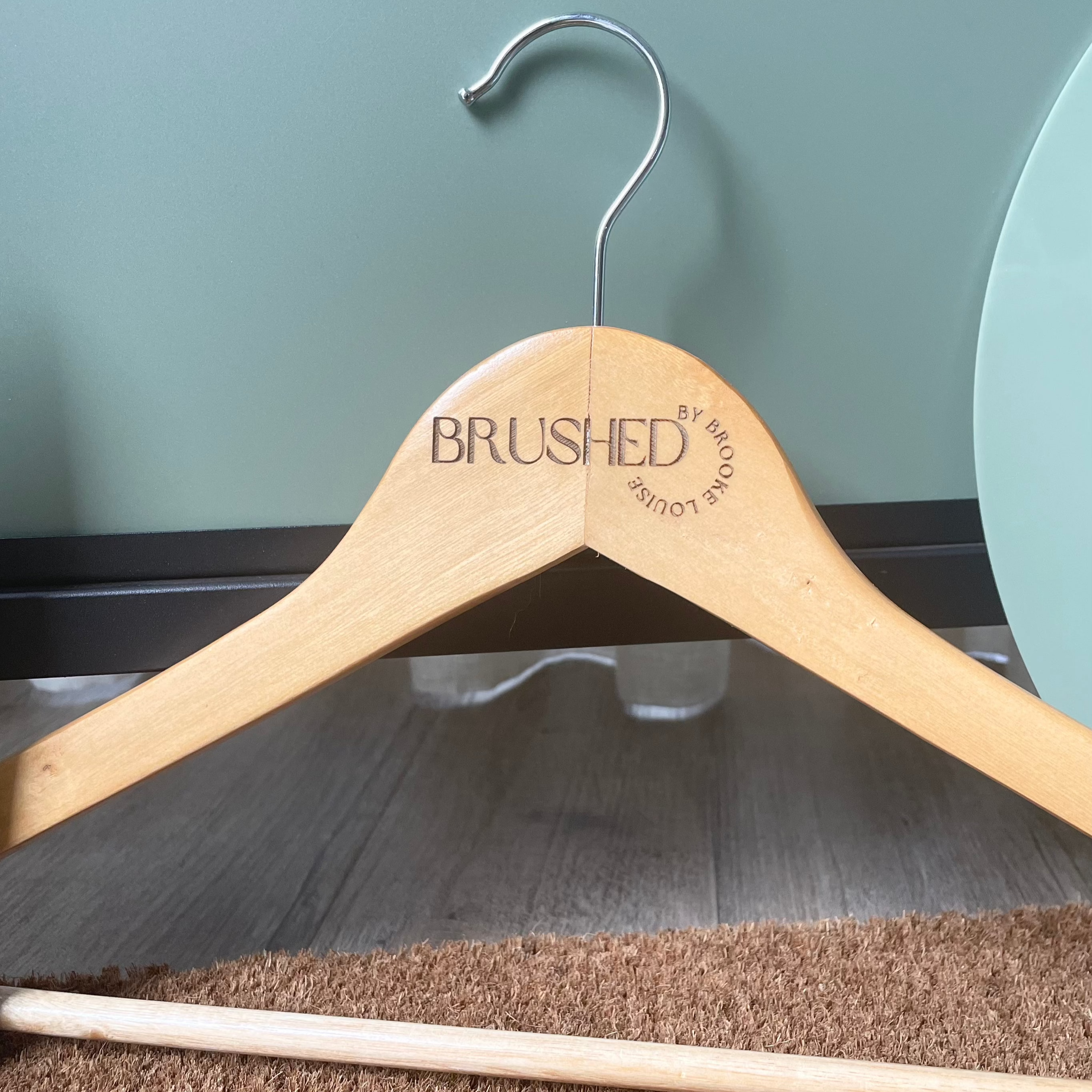 Branded wooden hanger with engraved logo for hotel or spa uniforms