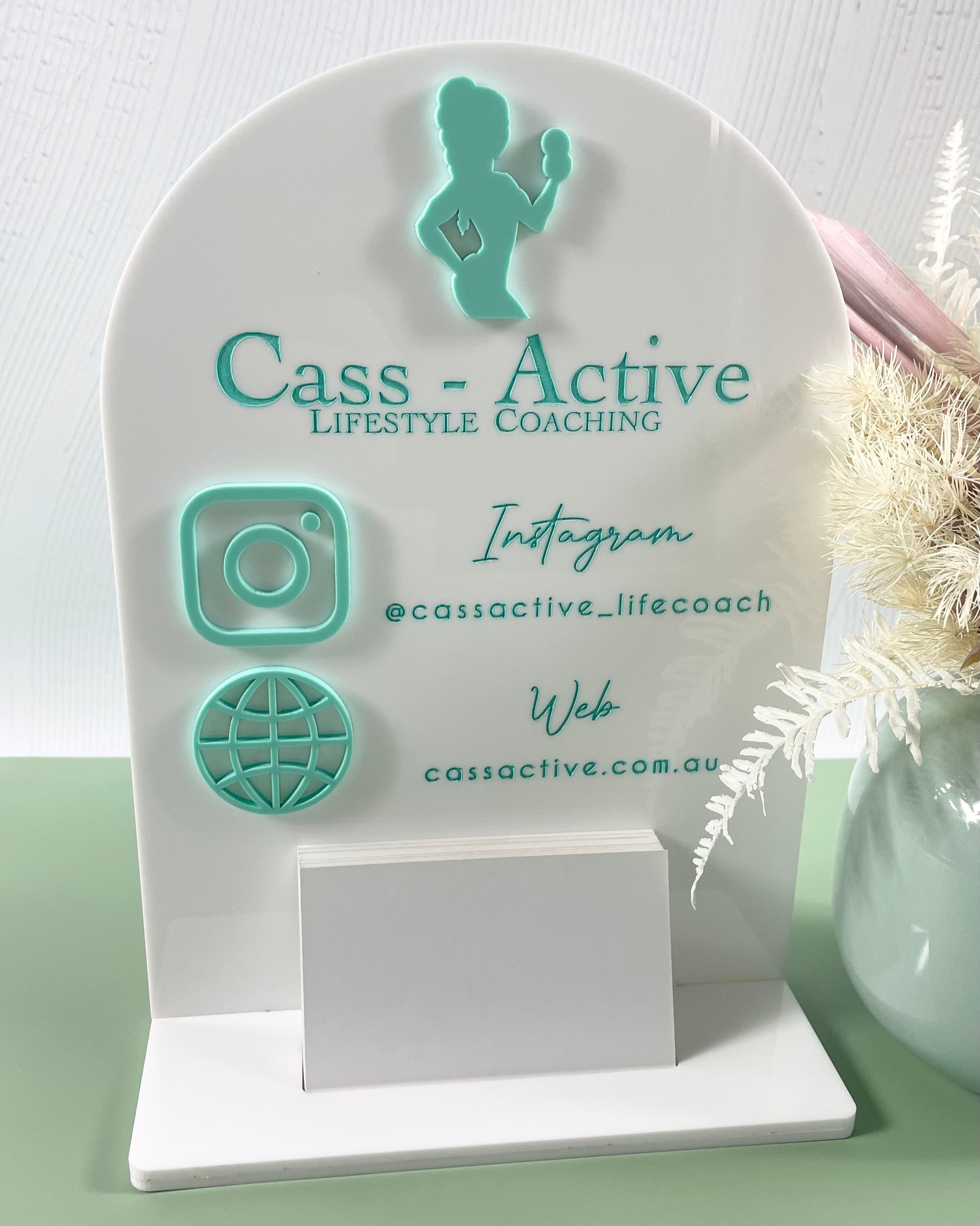 Mint green acrylic stand with Cass Active branding and social links