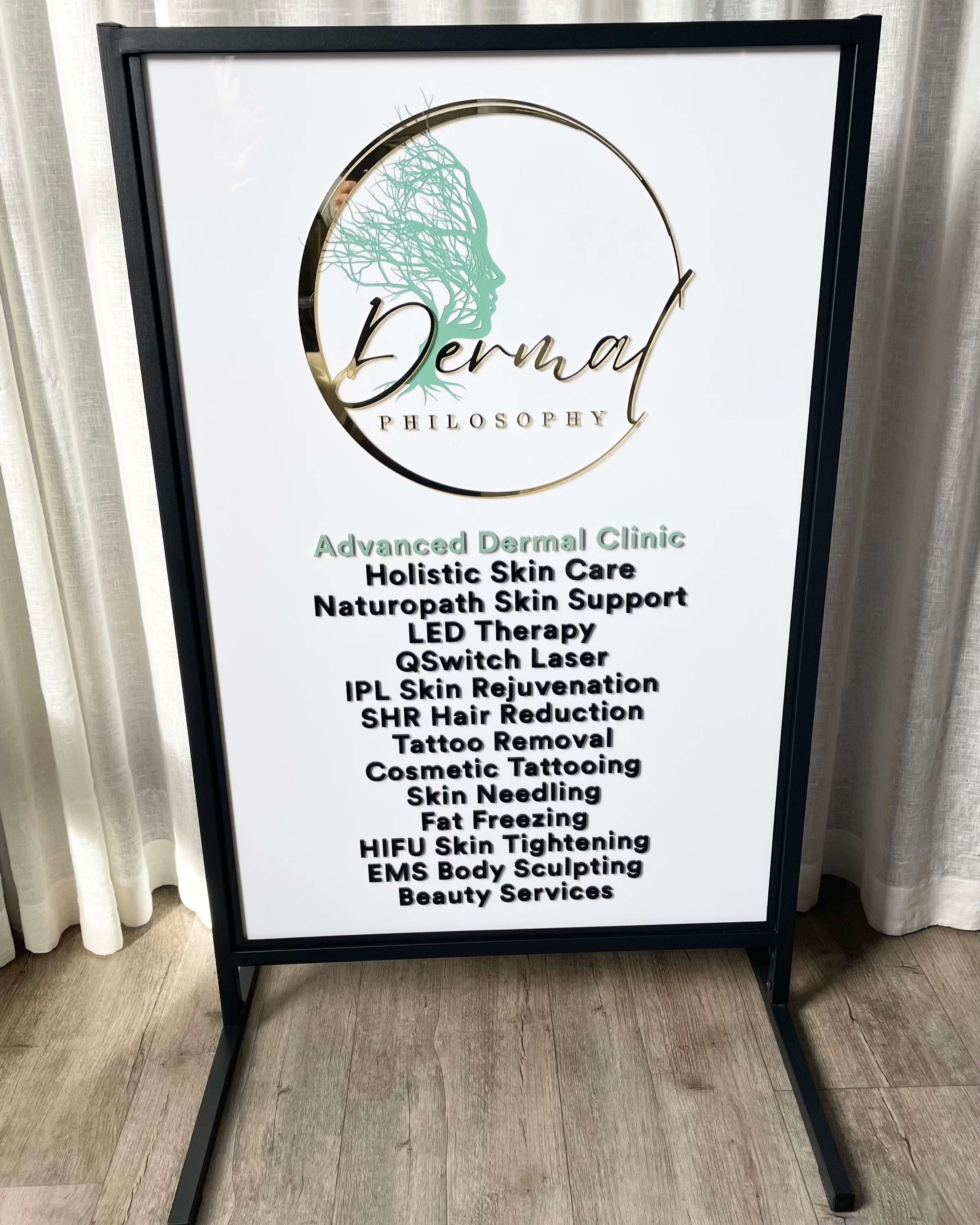 White acrylic T frame sign for cosmetic clinic services