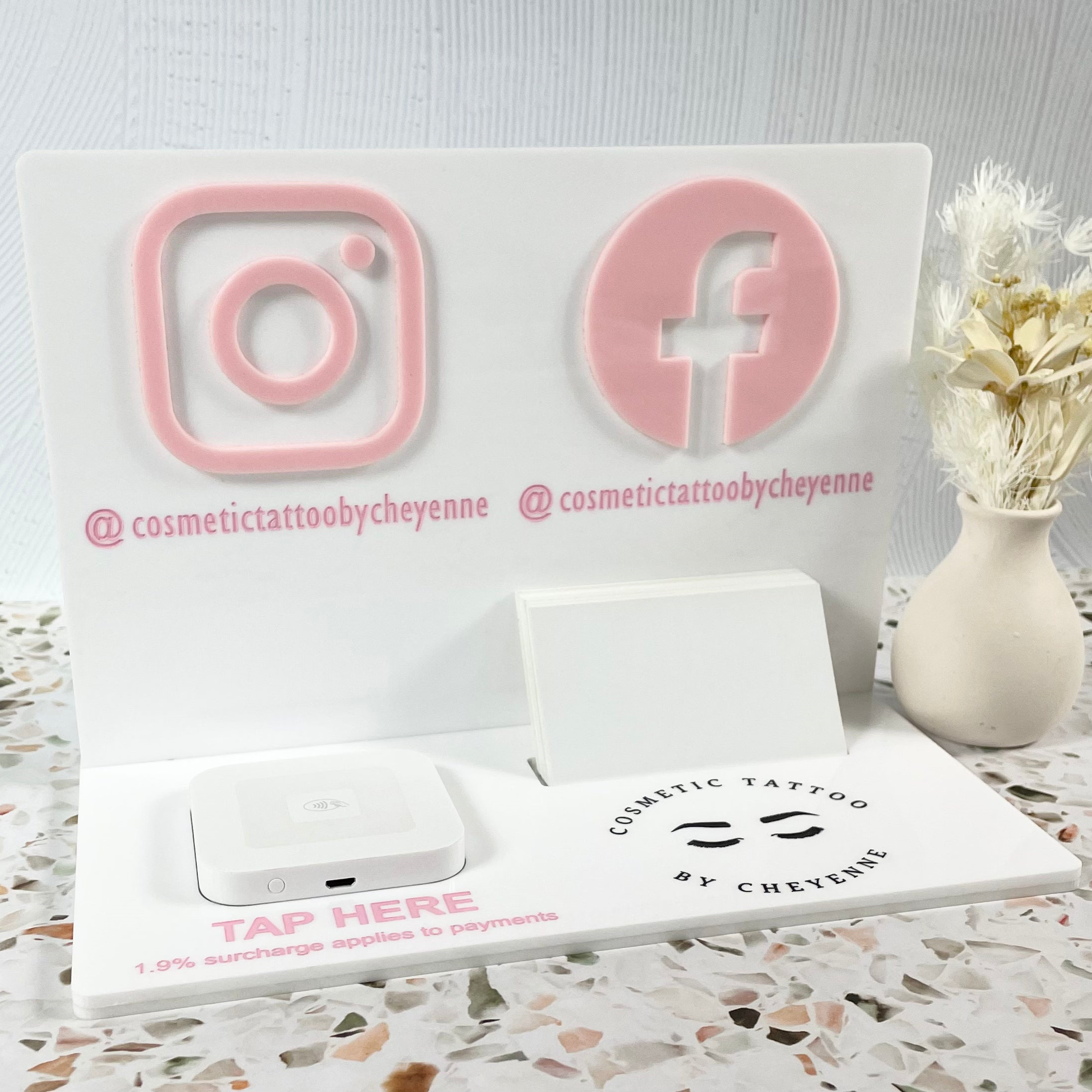 White acrylic station with custom gold social media icons