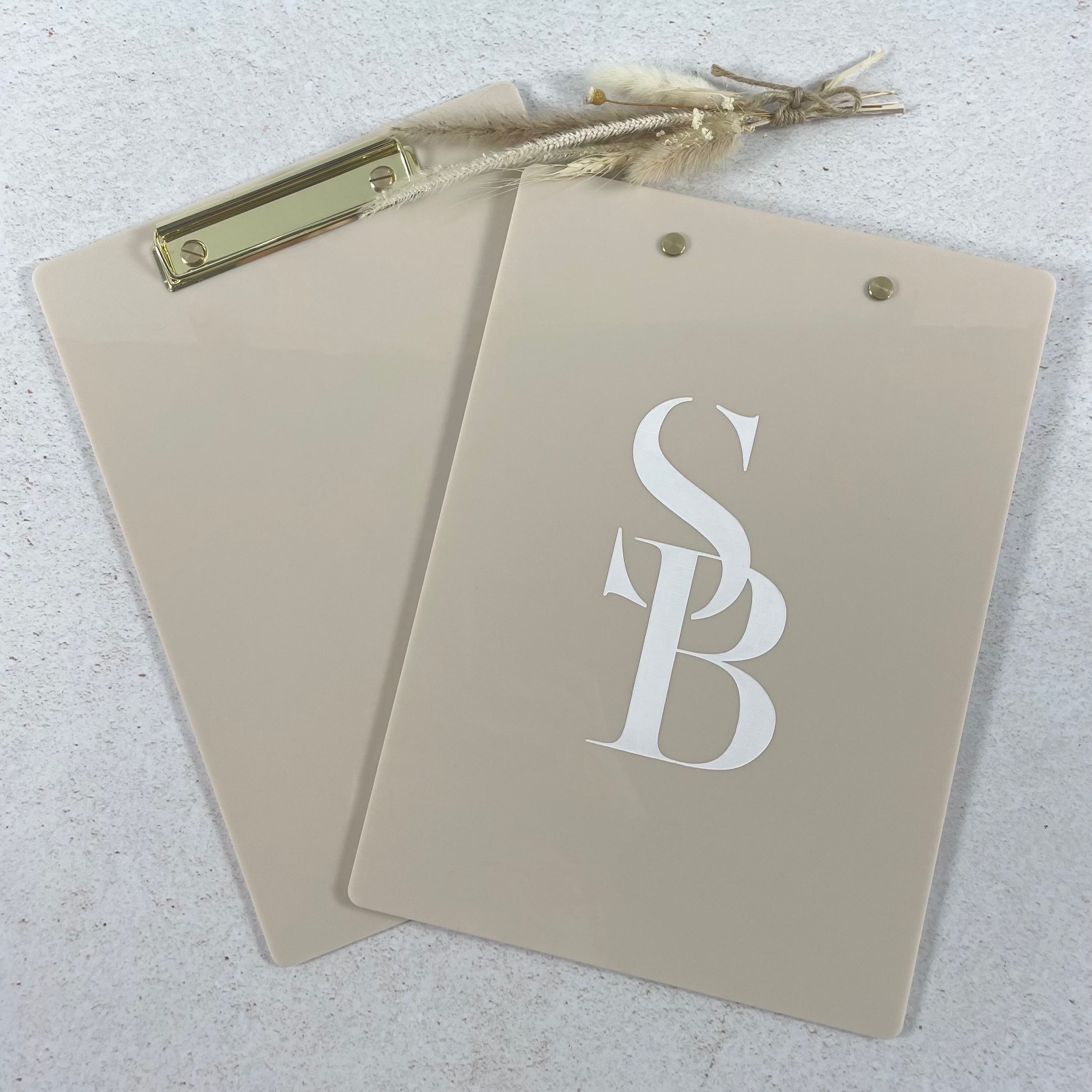 Branded clipboards with salon or clinic logos displayed together