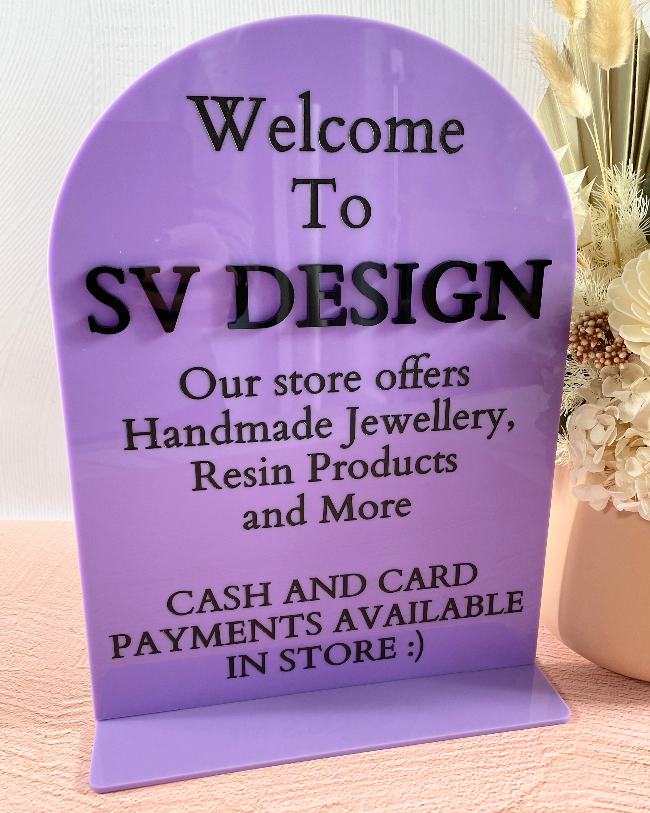 Purple welcome sign with payment info and store details