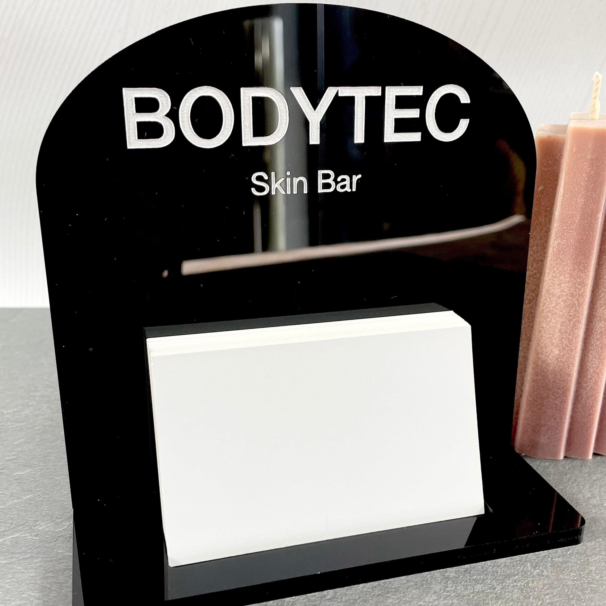 Black acrylic mini stand with Bodytec logo and card slot