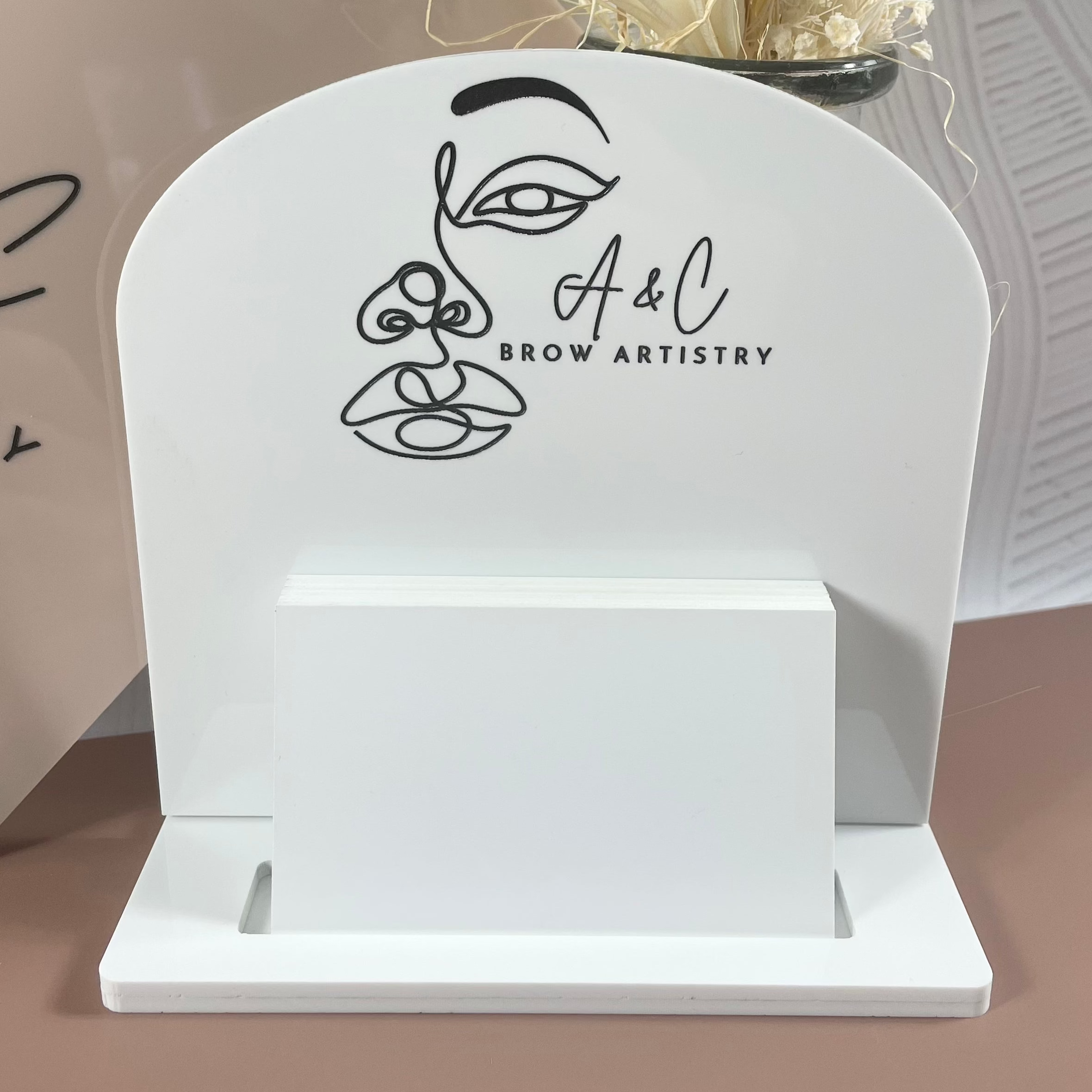 Custom white and gold card holder for BR Aesthetics reception desk