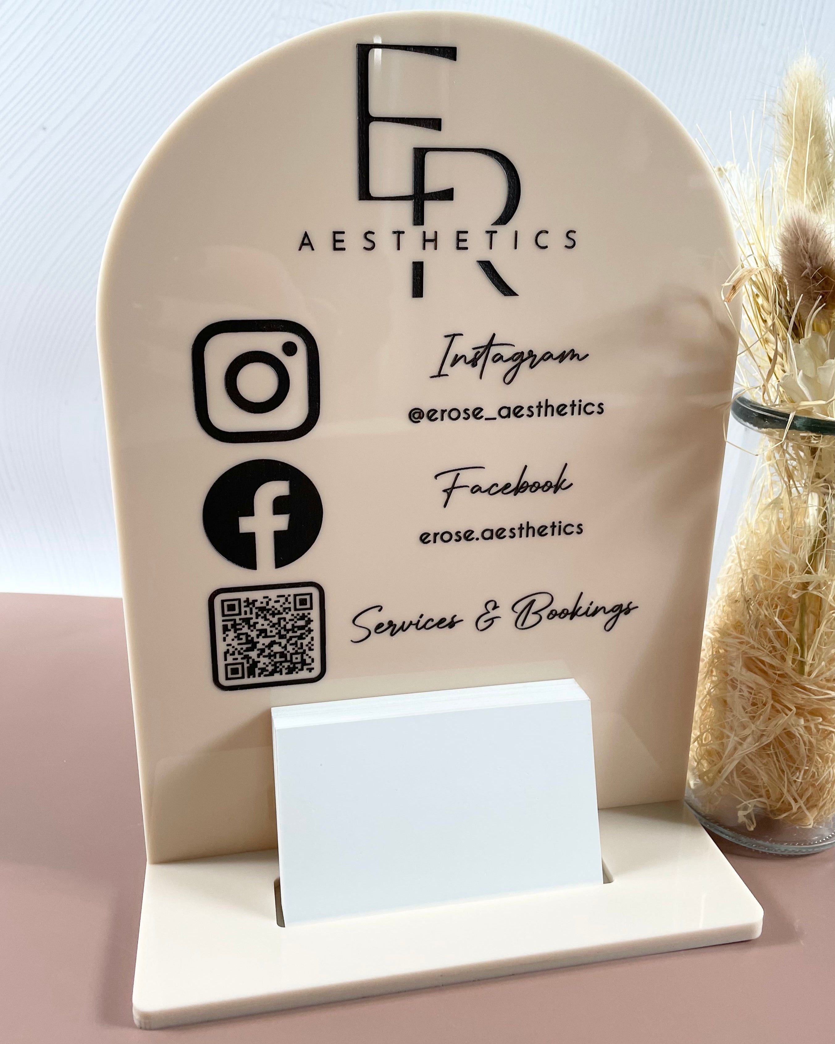 nude stand with multiple social media icons and business card slot