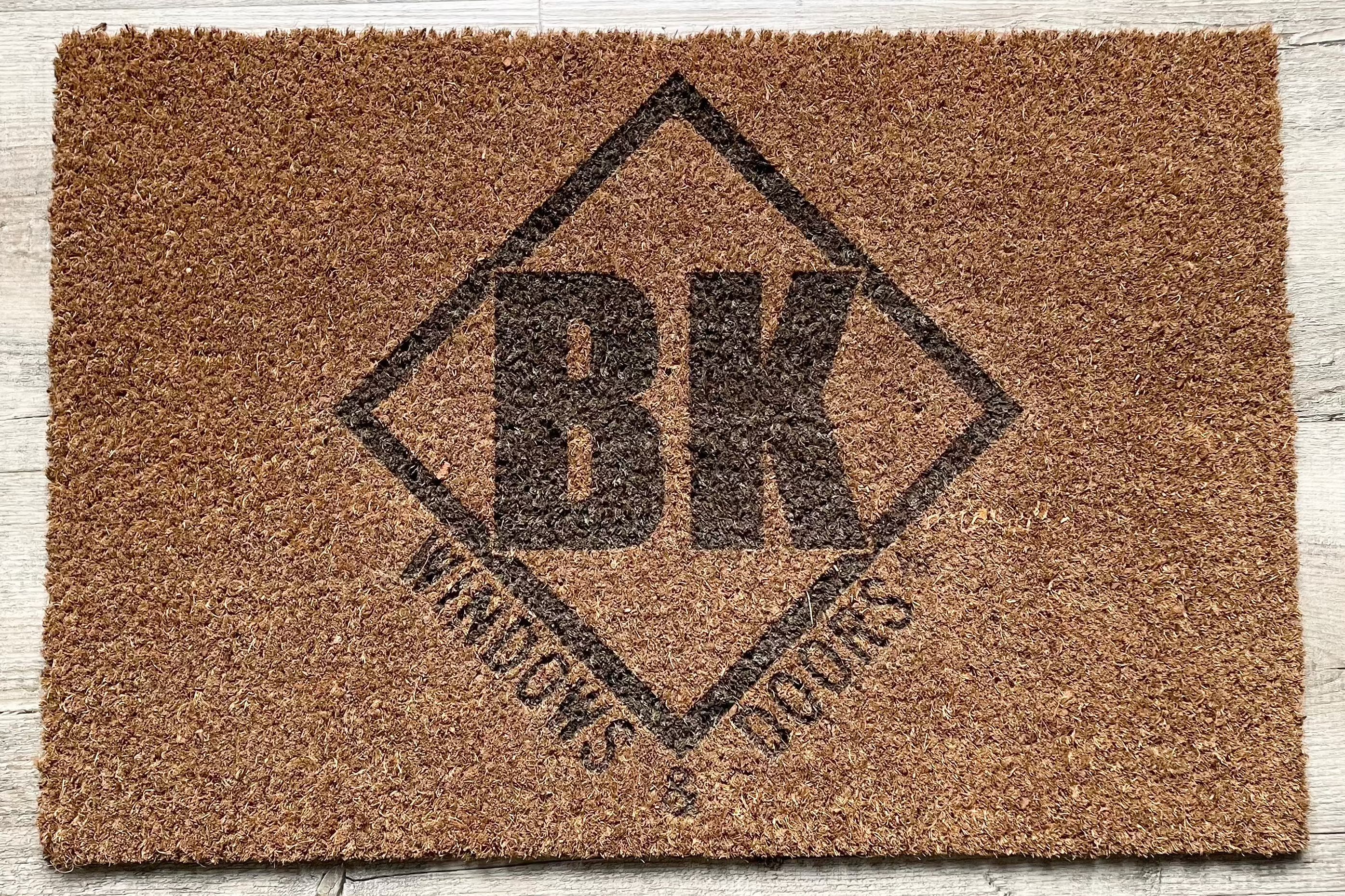 BK Windows and Doors logo on a custom branded mat