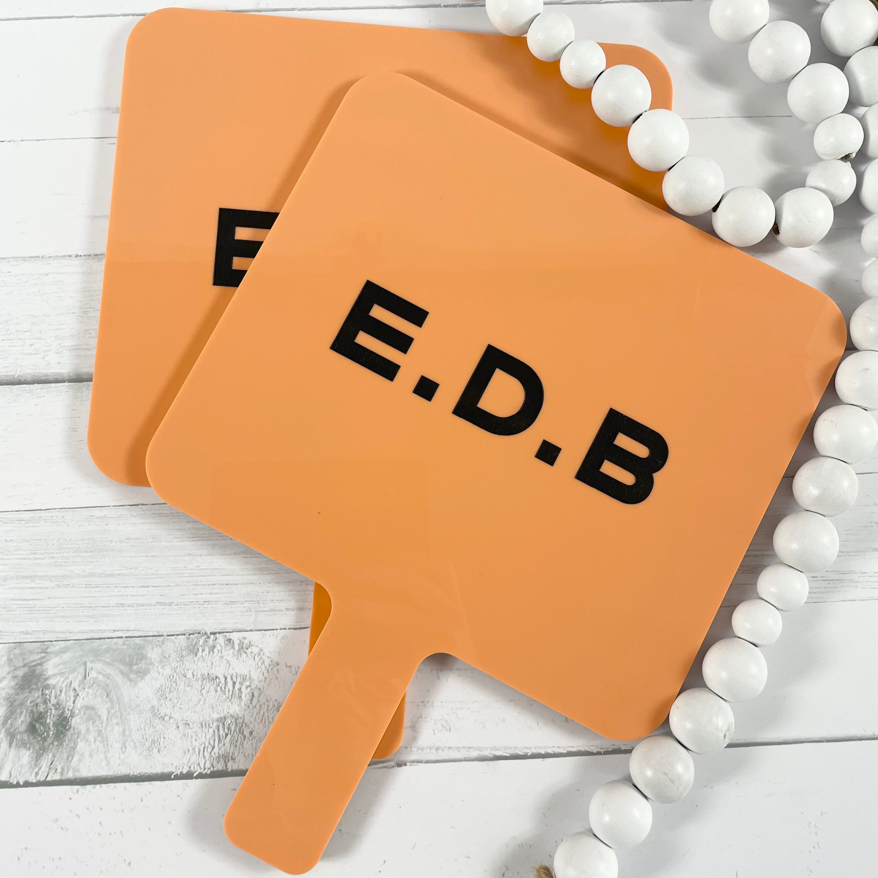 F E D B branded orange square handheld mirrors