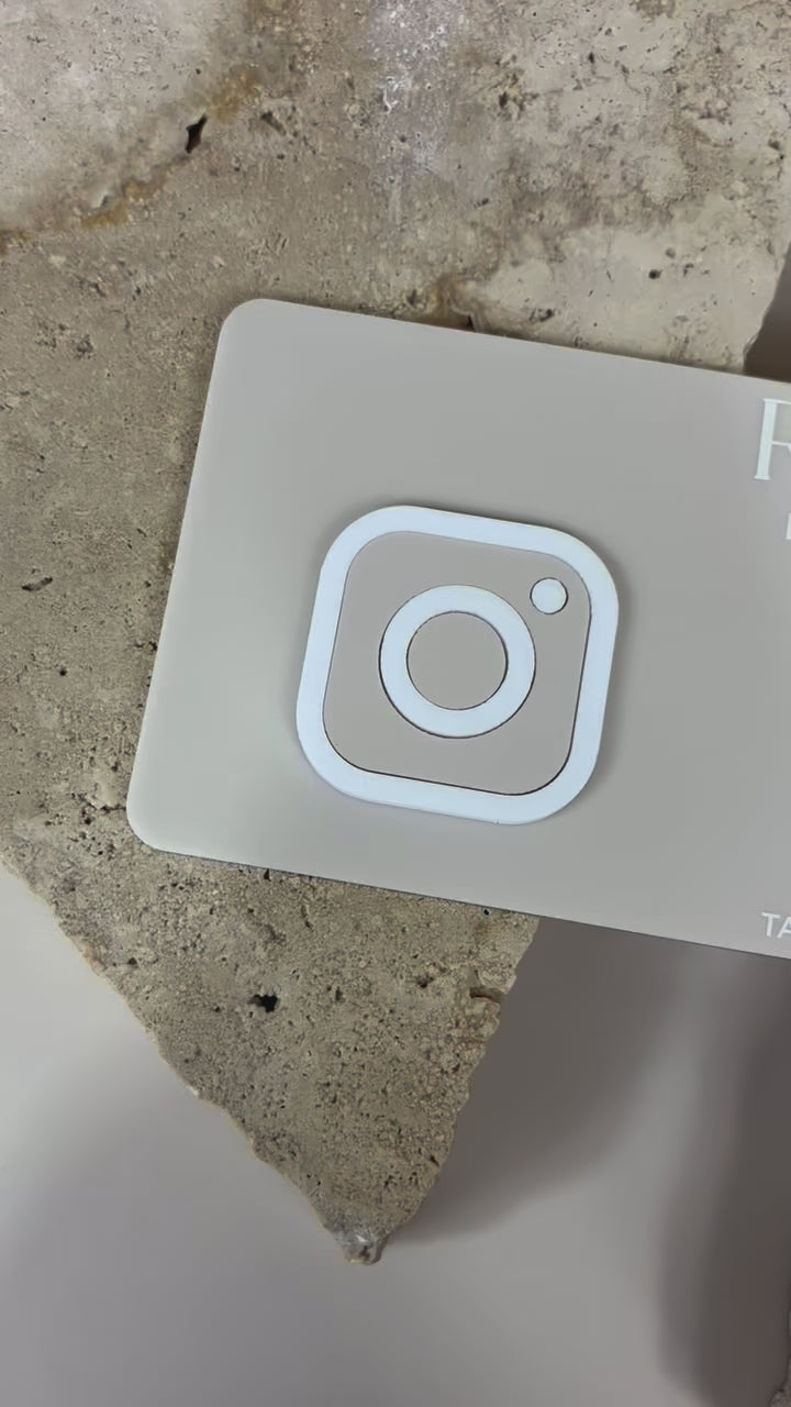 Close‑up of NFC social plaque with Instagram icon, designed for contactless sharing. Video