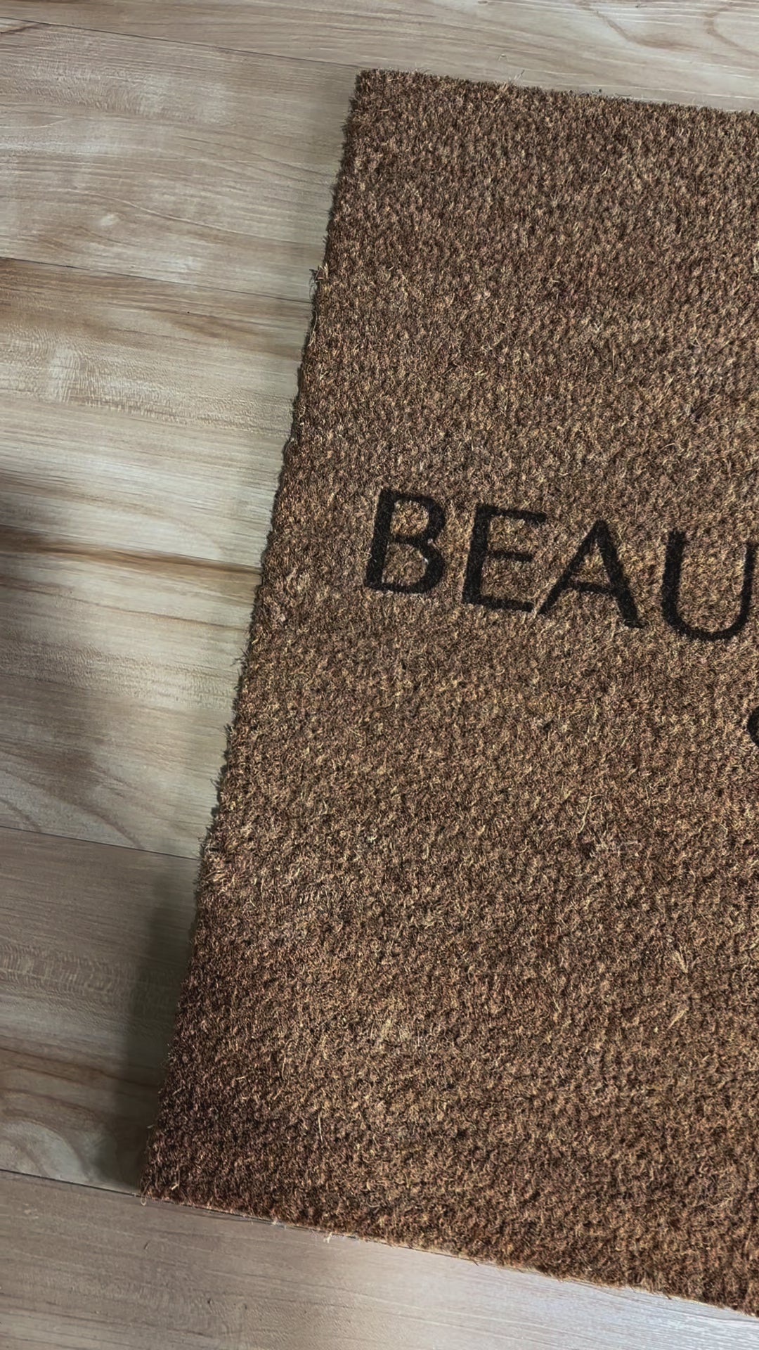 Close up of personalised beauty studio logo on a door mat. Video
