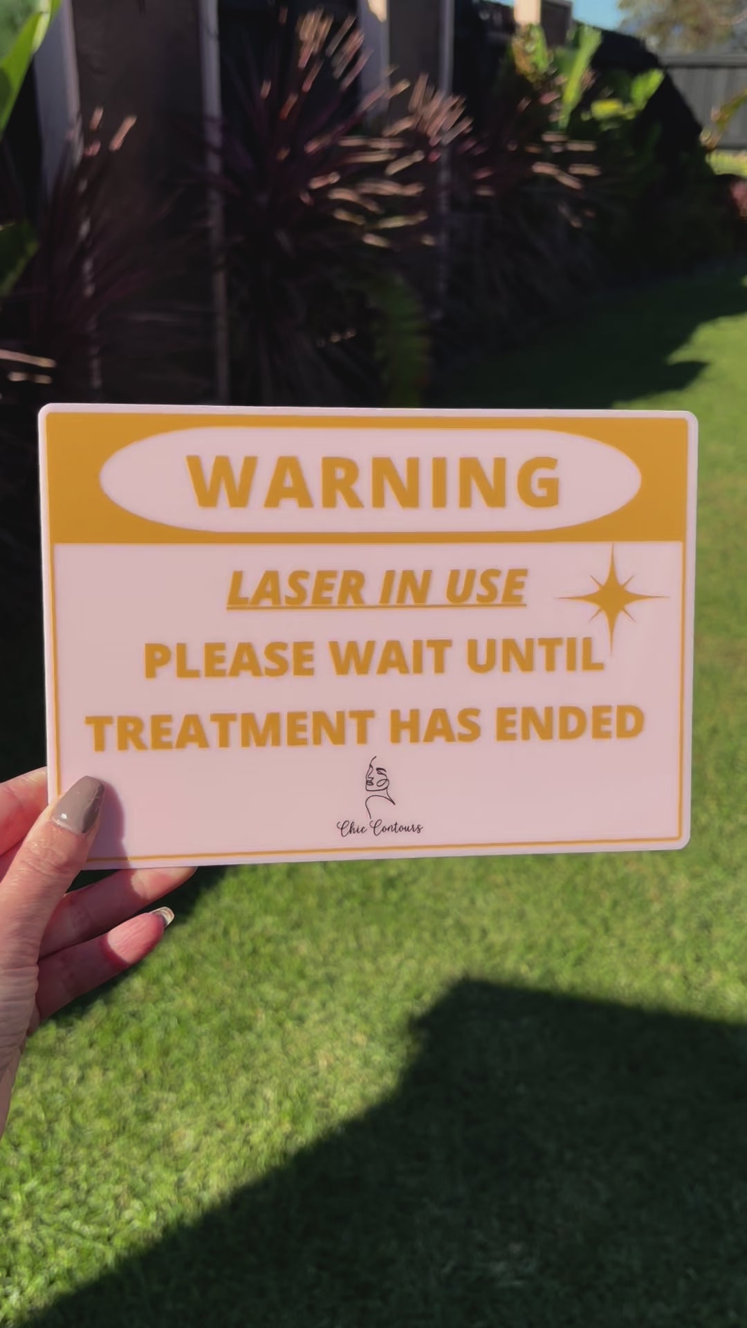 outdoor view of yellow laser in use warning sign, safety notice for salons and clinics. Video