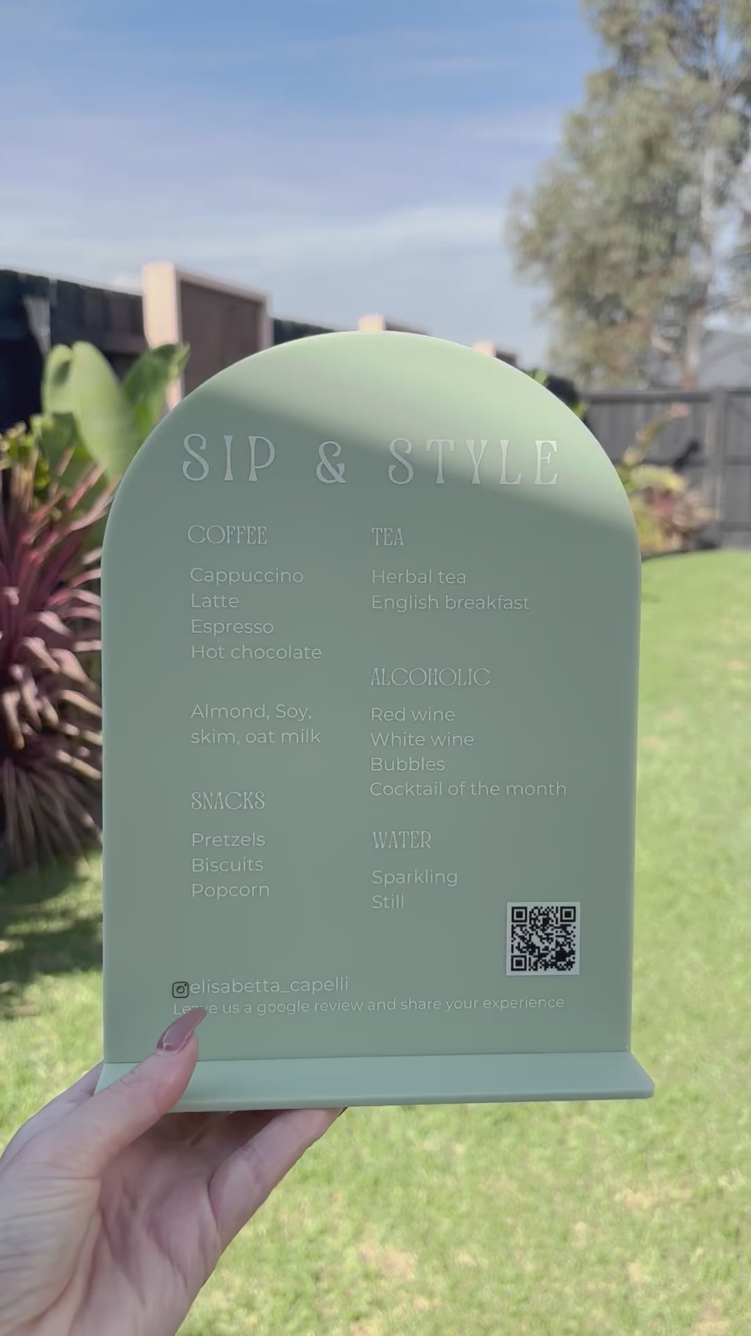 Green arched acrylic product sign with custom QR code and business branding. Video