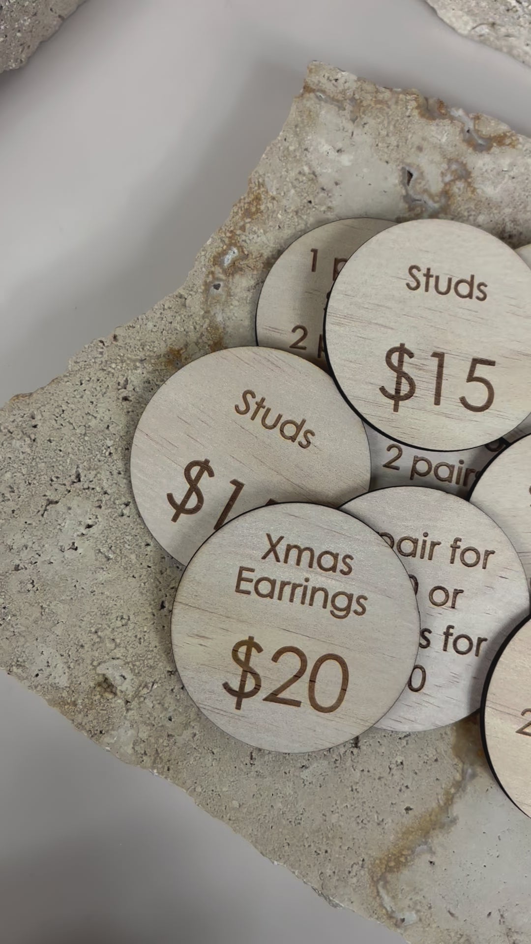 Close up video still of round product price discs showing $15 and $20 tags