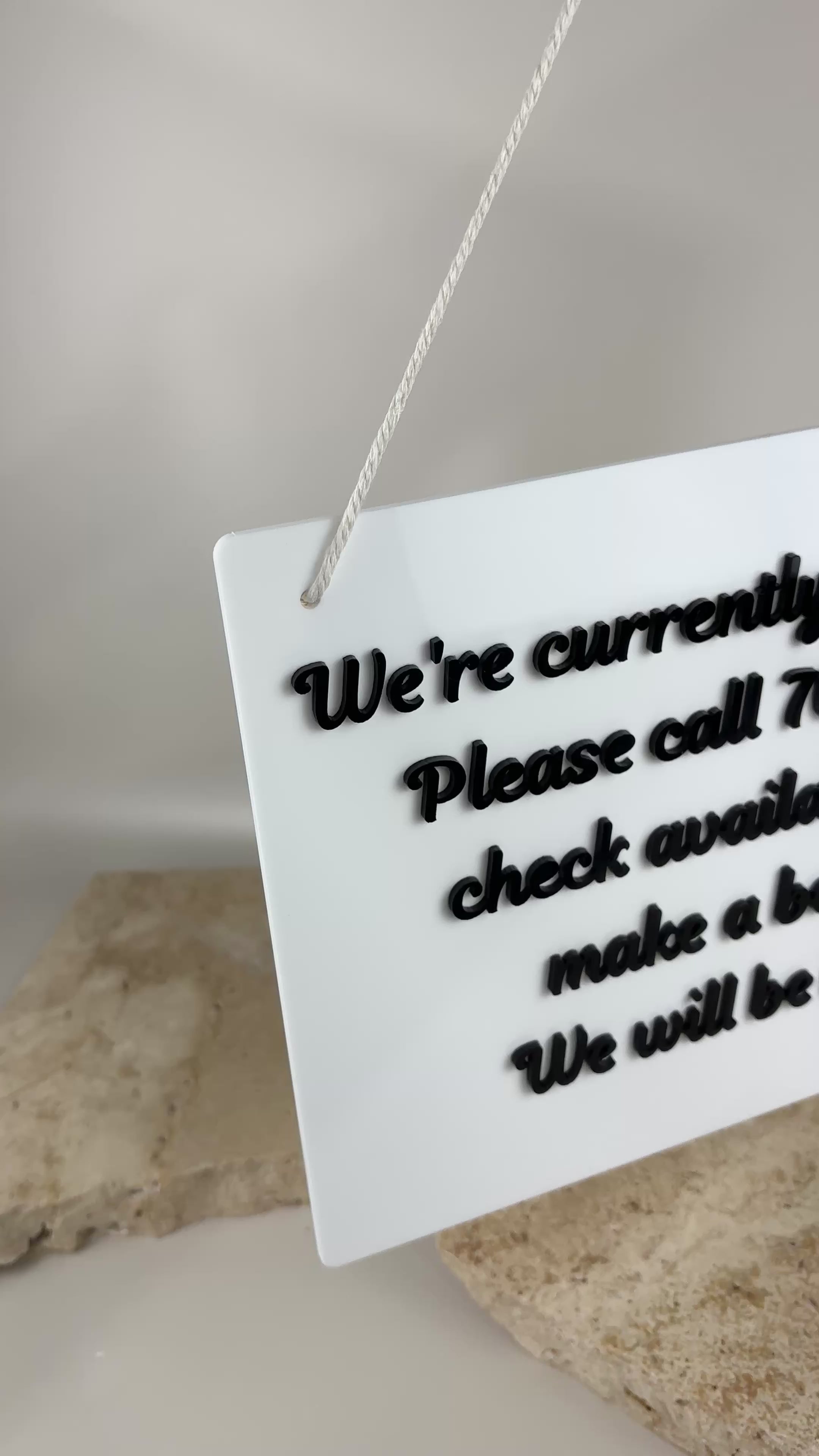 Custom acrylic salon door sign video showing we’re with a client message, personalised business signage with contact number and booking details, perfect for salons and clinics.