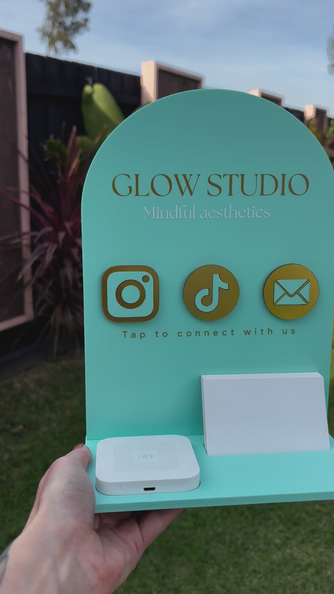Personalised NFC business station in teal with square dock and card holder – Glow Studio logo with social media icons. Video