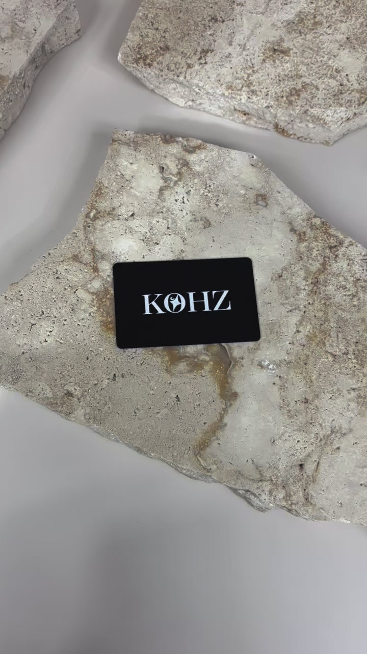 Black matte NFC smart card with custom business branding on textured surface video