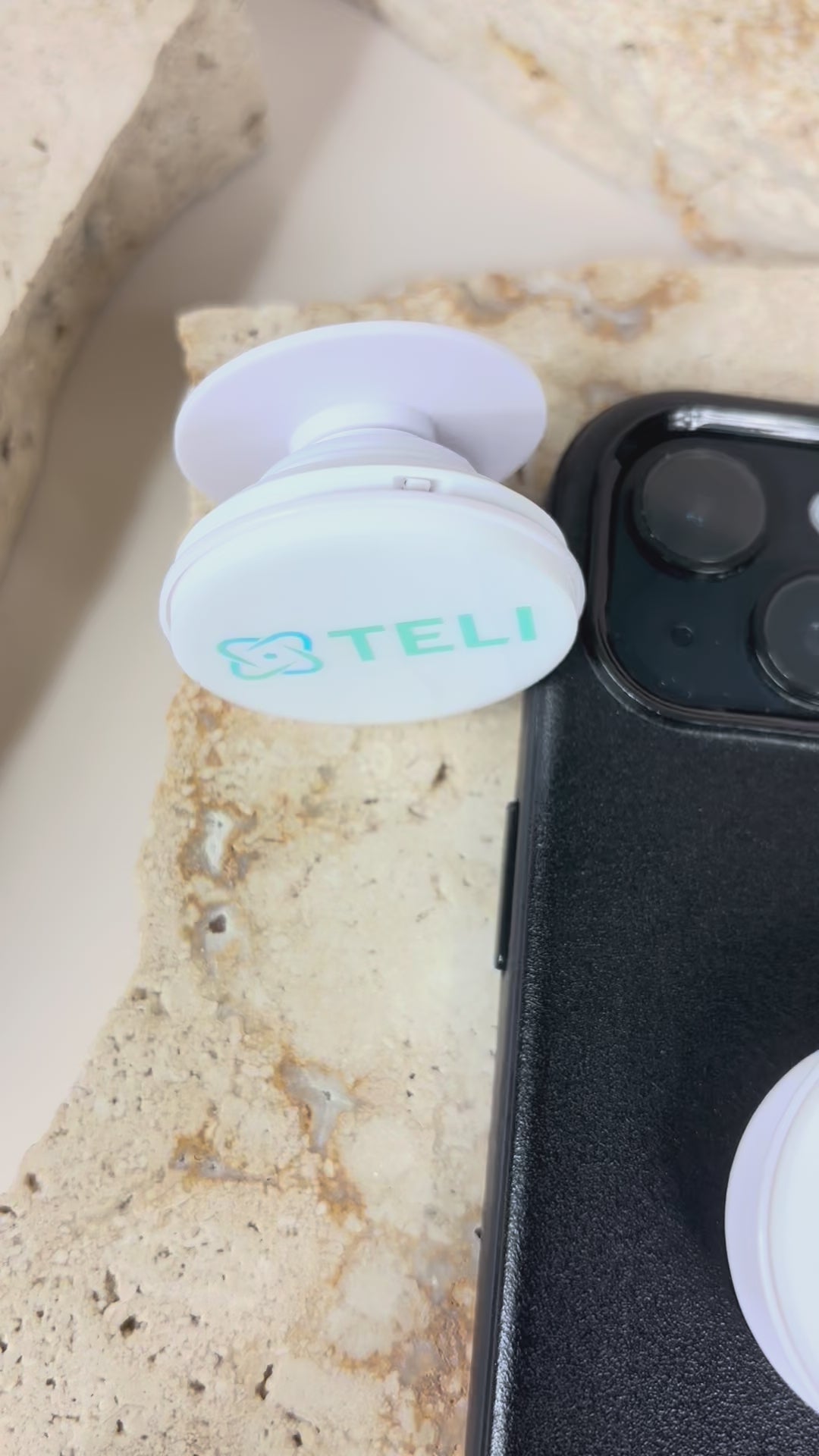 Close up of white promotional phone grip with logo on phone case. Video