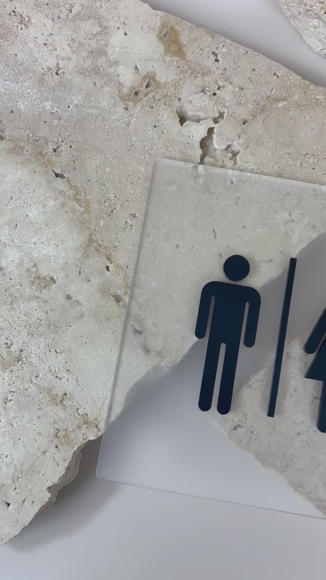 Acrylic unisex accessible restroom door sign featuring male, female and wheelchair symbols on textured surface