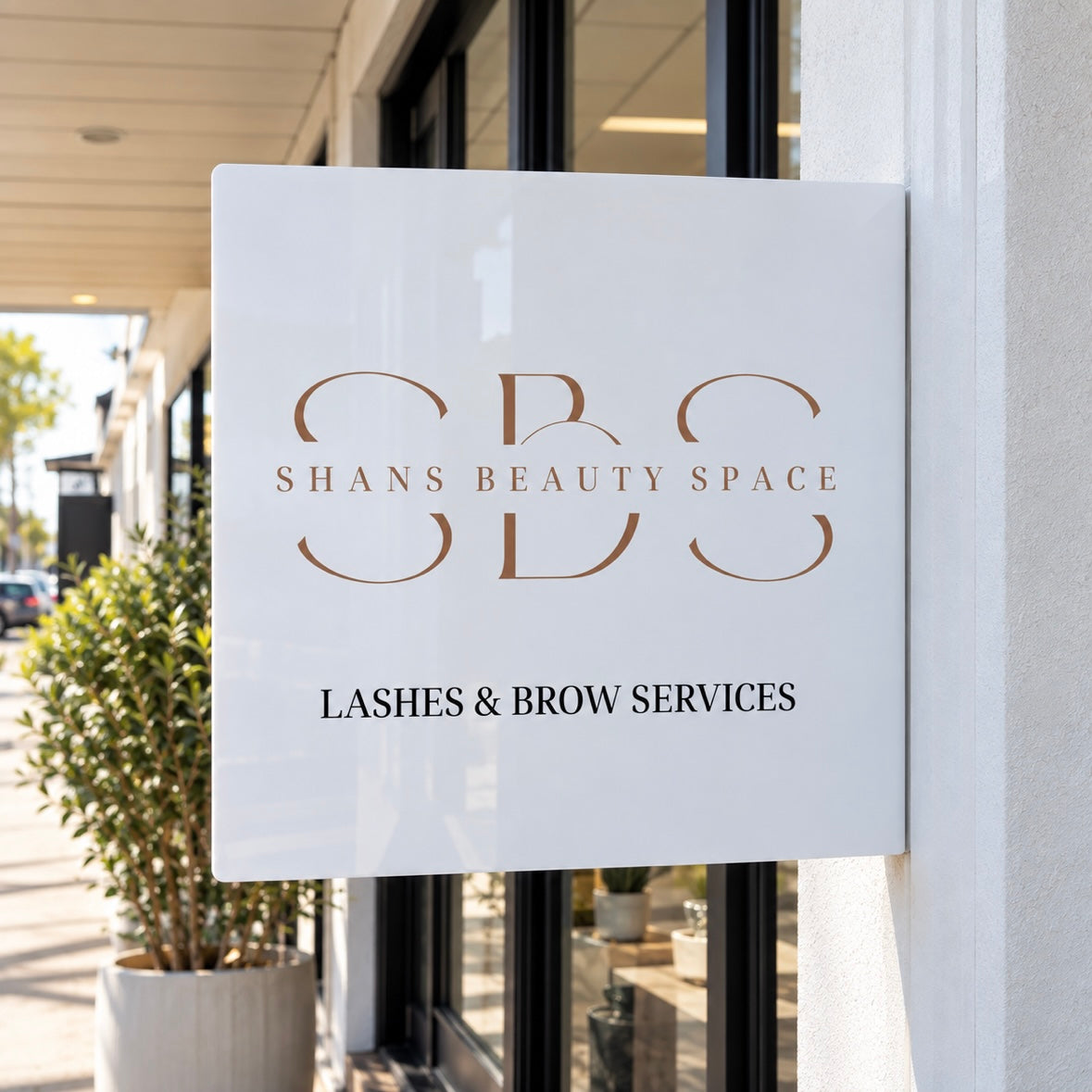 Custom white acrylic blade sign for Shans Beauty Space, featuring lashes and brow services outside a modern beauty salon.