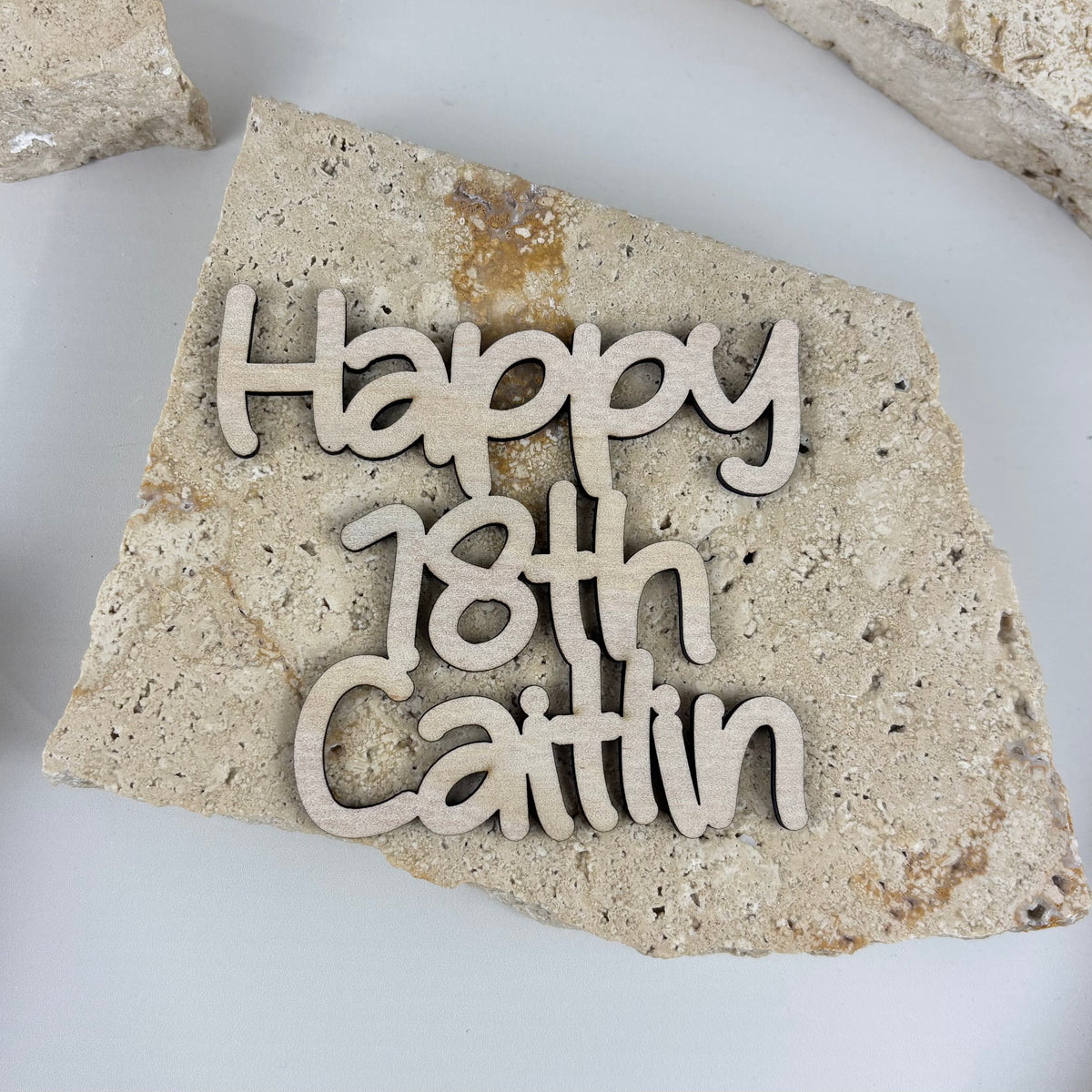 Personalised timber cake froppers with custom names and ages for birthday cake decorations.