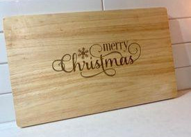 Custom engraved Christmas chopping board made from premium wood with decorative Merry Christmas engraving