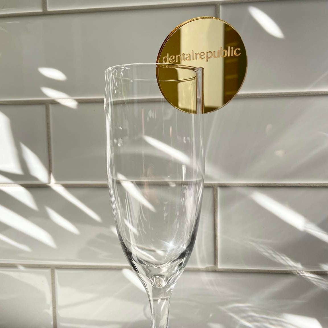 Gold mirror drink tag on a clear glass for a premium look