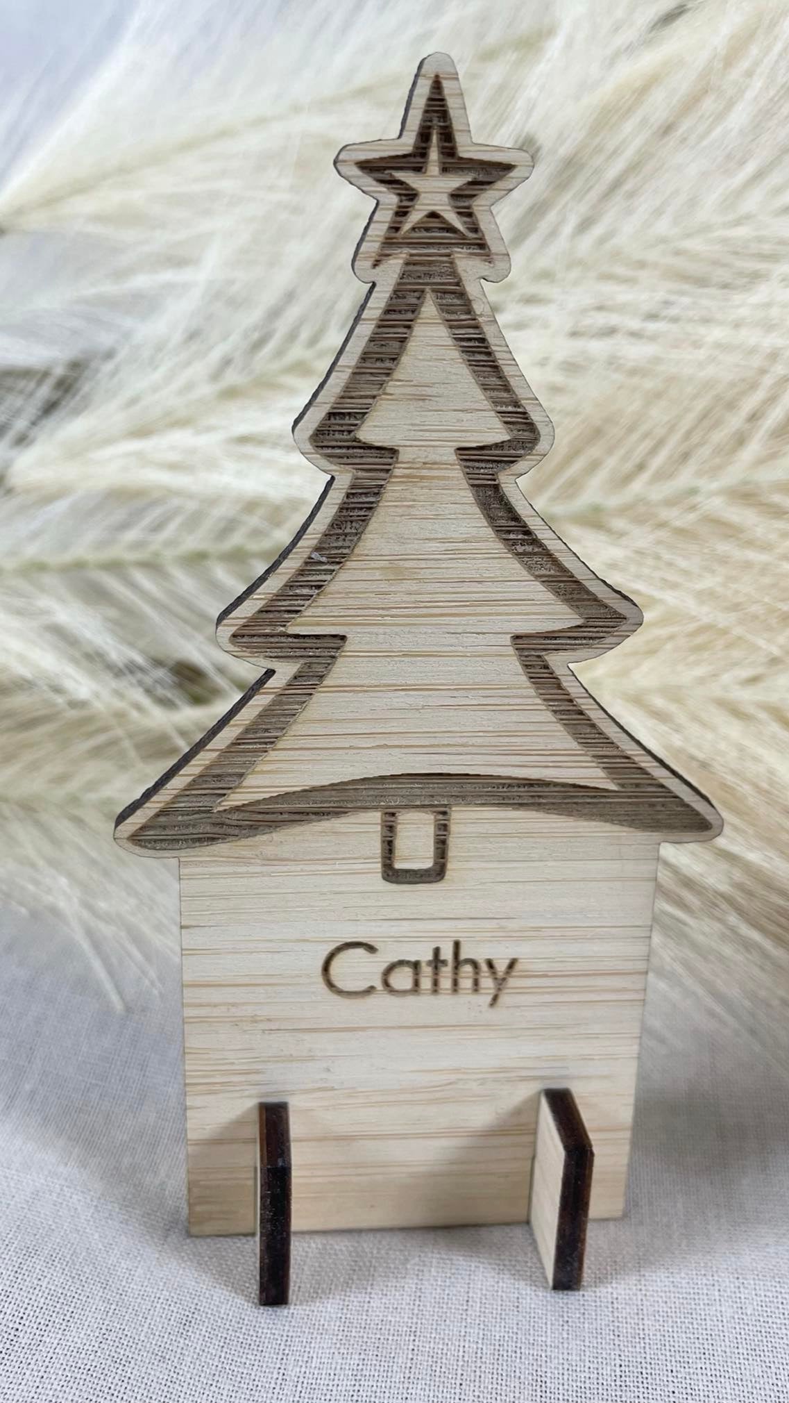 Personalised wooden Christmas place card with engraved tree design for festive table setting