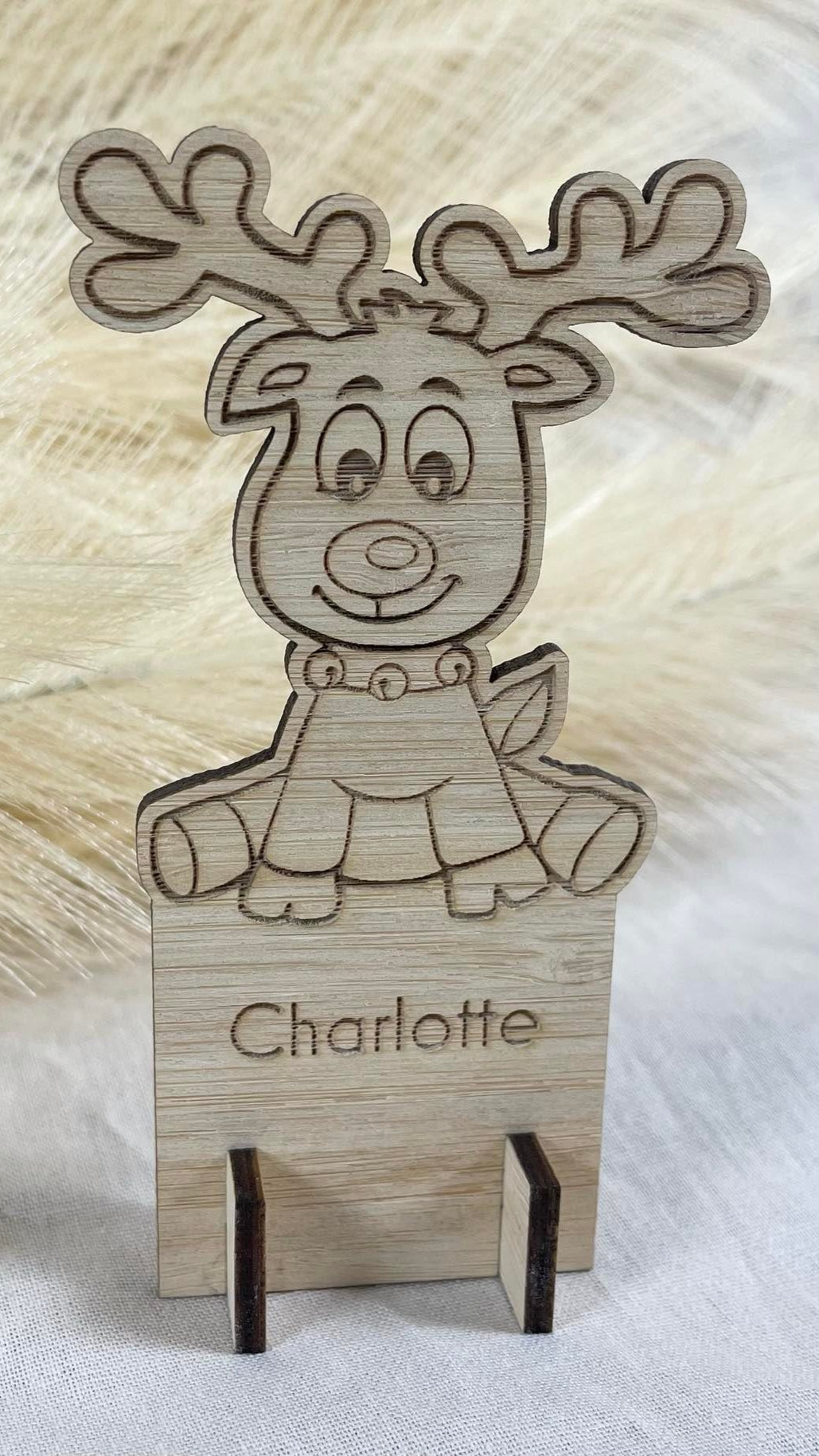 Custom engraved Christmas place card featuring reindeer character design with personalised name
