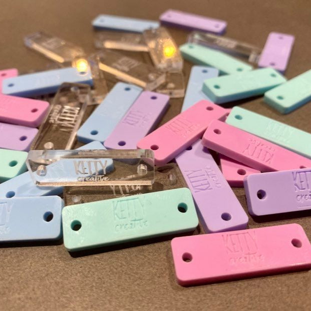 Assorted pastel acrylic rectangle product tags with custom engraving