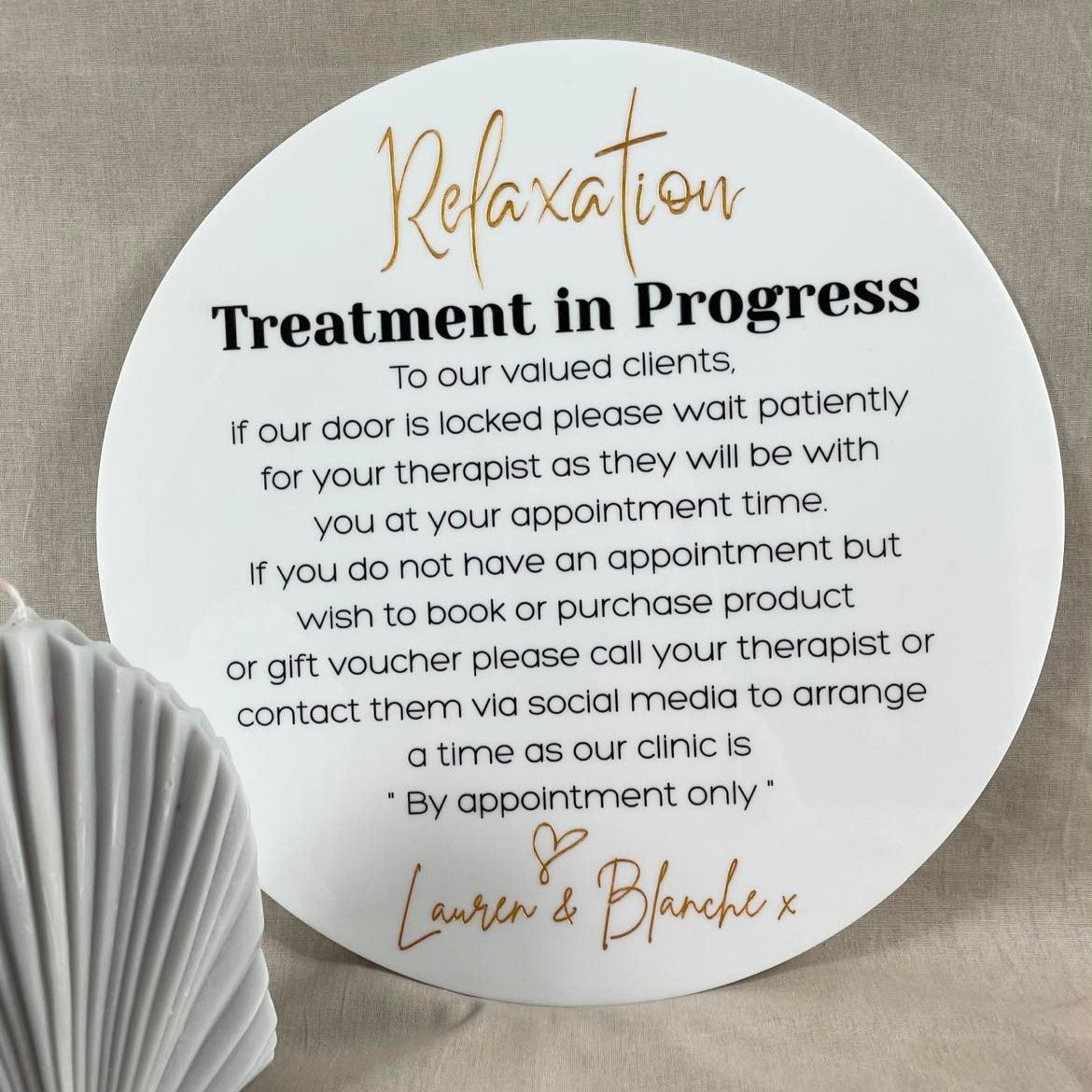 White round treatment in progress sign for beauty salon on beige fabric