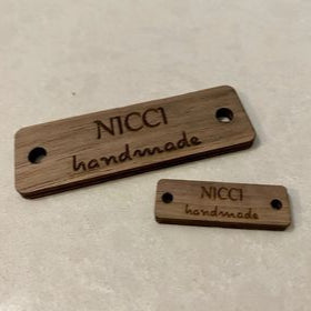 Two engraved wooden rectangle tags with handmade business branding