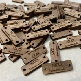 Bulk order of custom wooden rectangle product tags with engraved branding