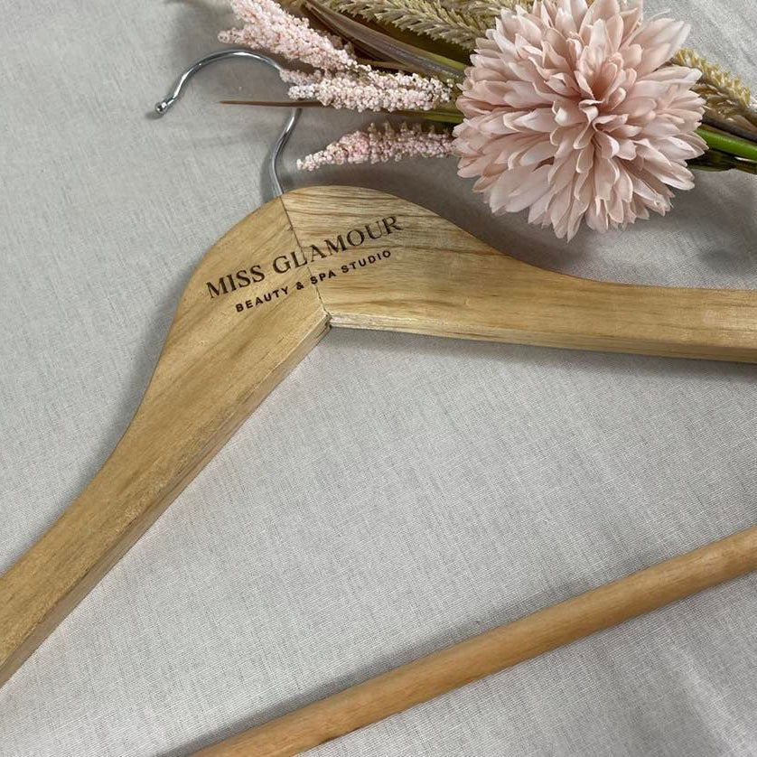 Personalised coat hanger for boutique clothing store with floral styling