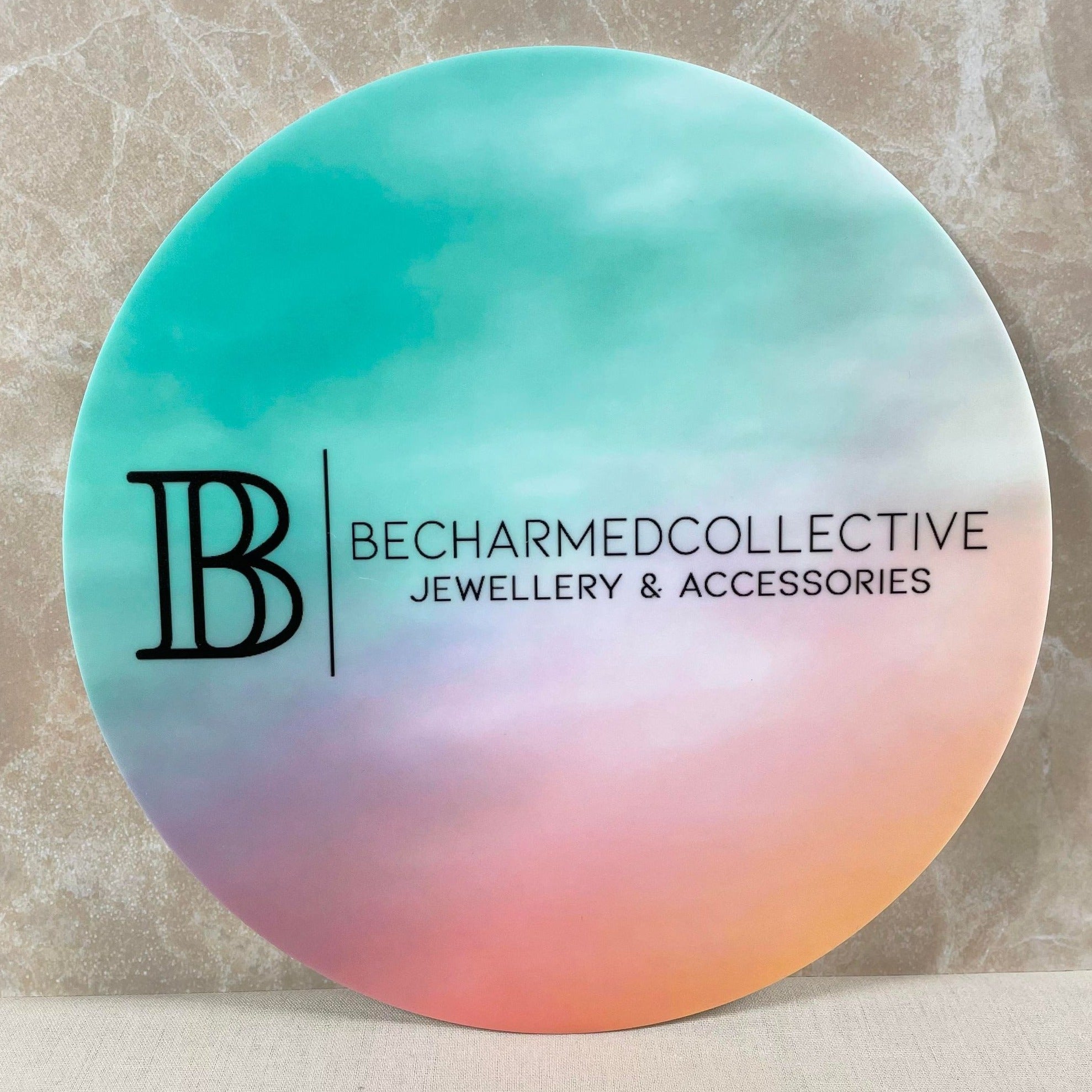 Pastel gradient UV sign for Becharmed Collective
